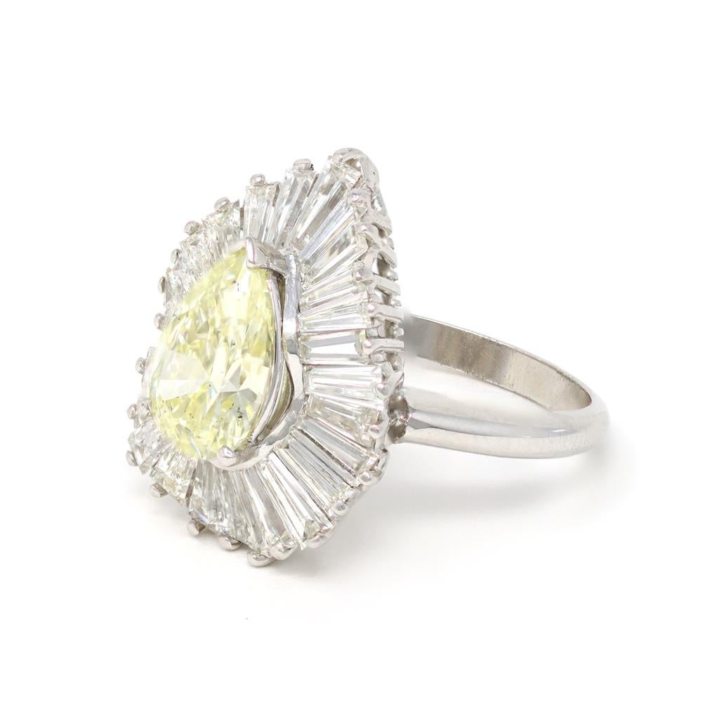 A Platinum Ballerina Diamond cocktail ring circa 1950 set in the center with a pearshape light yellow Diamond weighing 1.99 carats and surrounded by baguette-cut Diamonds weighing approximately 3.00 carats. The ensemble, set in a Platinum mounting,