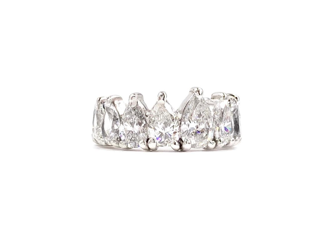 An exquisite find. This platinum prong set eternity pear shape diamond ring features 16 graduated diamonds at approximately 5.56 carats total weight. Diamonds are very well matched with similar color and clarity throughout, approximately G-H color,