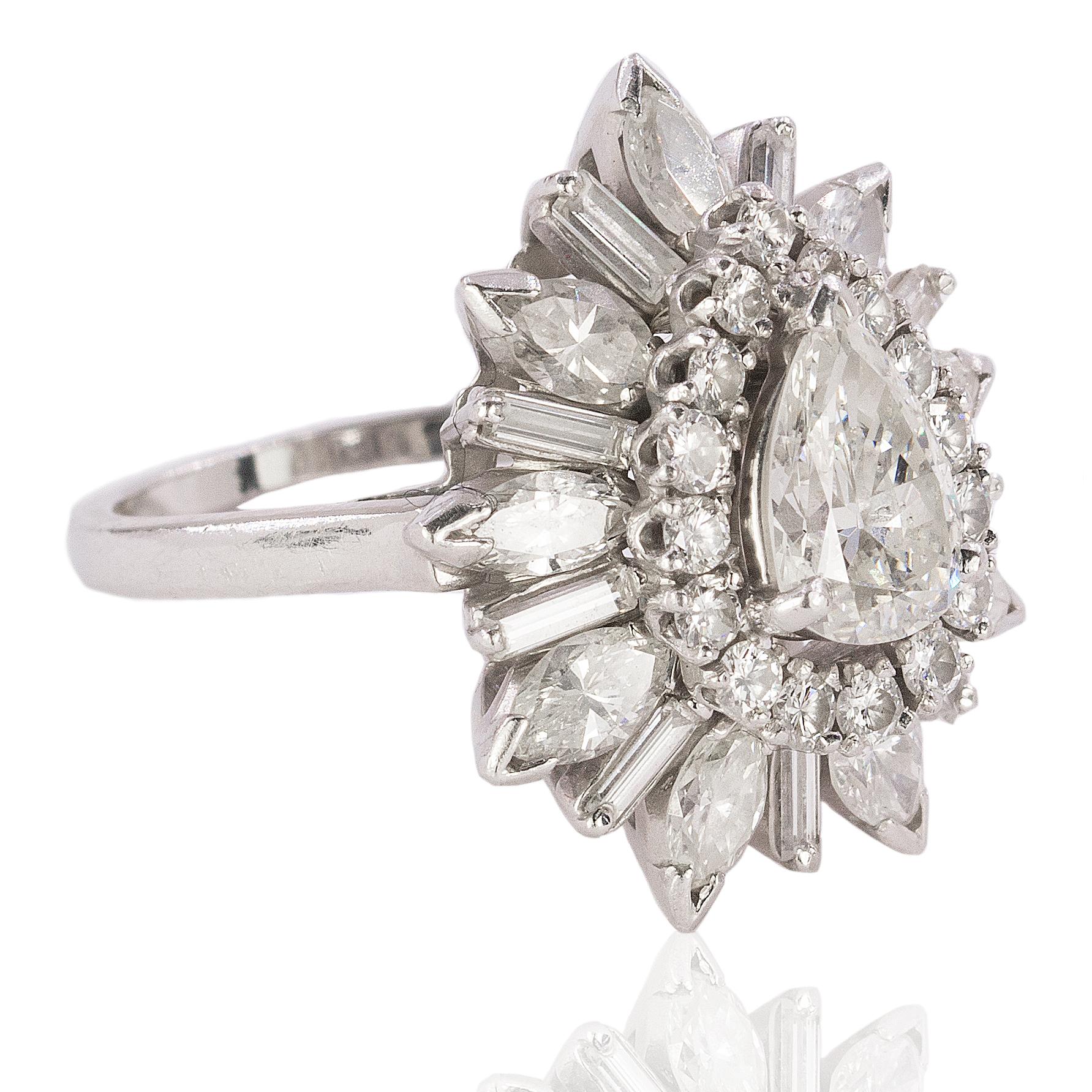 Platinum ring with approximately 1.25 carat pear shape high color, high clarity diamond and approximately 4.00 carats of round, marquis and baguette cut diamonds. 12.56g
