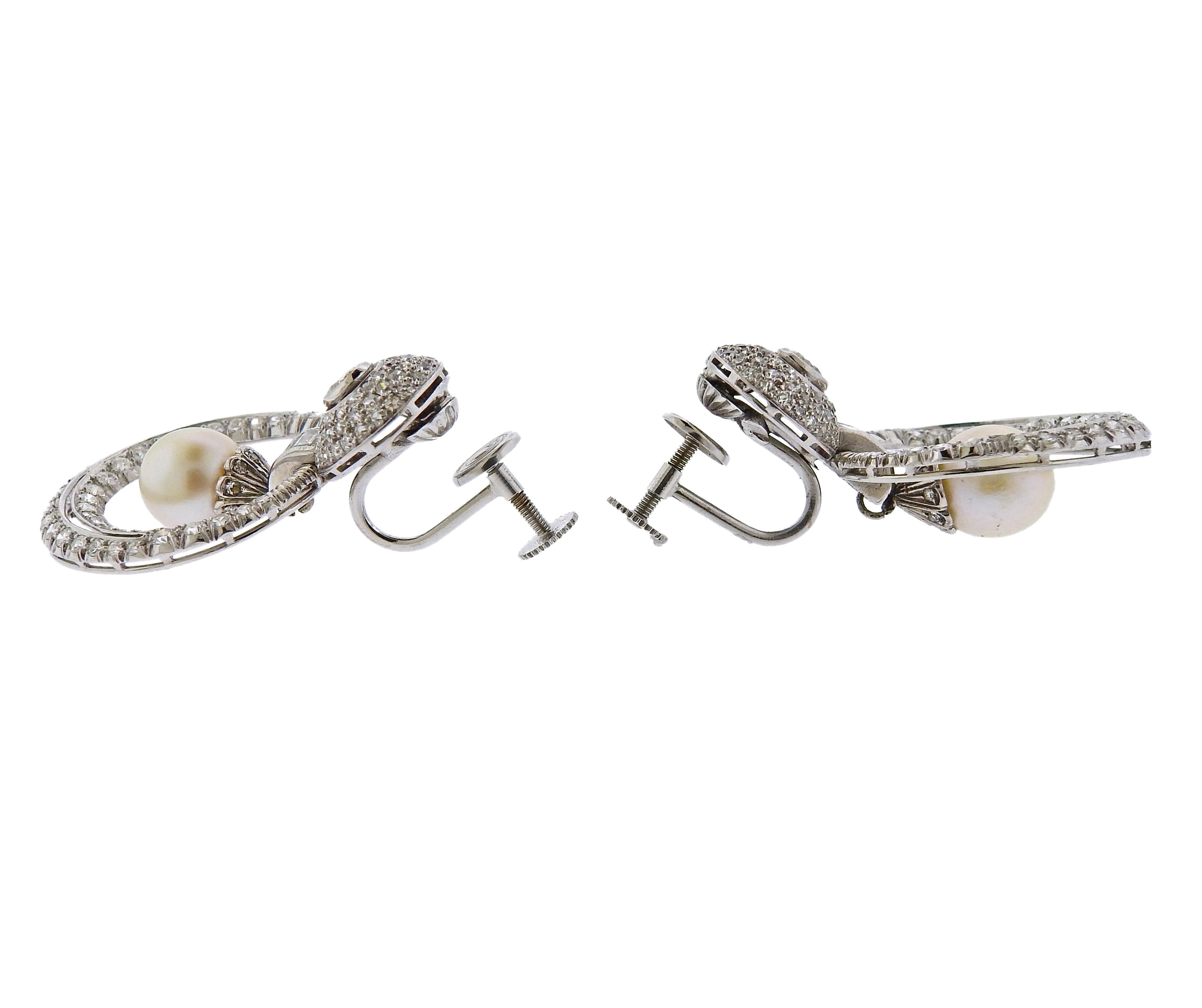 Pair of platinum doorknocker earrings, set with 9mm pearls and approx. 4.00ctw in diamonds. The back hardware is marked 14k, earrings tested platinum. The earrings measure 38mm x 25mm. Weigh 17.7 grams.

SKU#E-02036