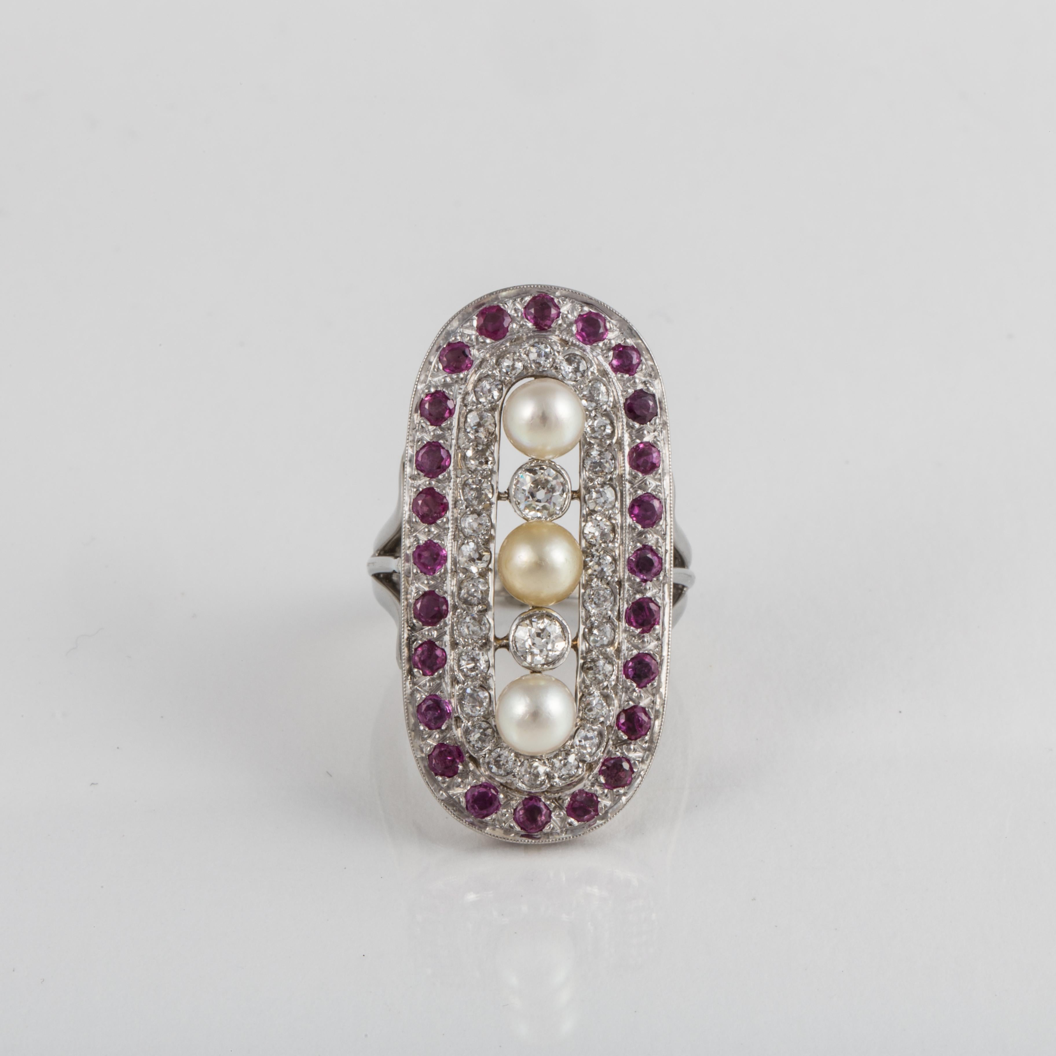 Elongated style plaque ring in platinum with a rubies, cultured pearls and diamonds.  There are thirty (30) round diamonds totaling 2.50 carats; H-I color and VS-SI clarity.  In addition, there are 24 rubies and three cultured pearls.  Measures 1