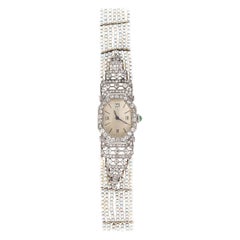 Montre pour femmes en platine:: perles:: émeraudes:: émail et diamants Art Nouveau:: 1930