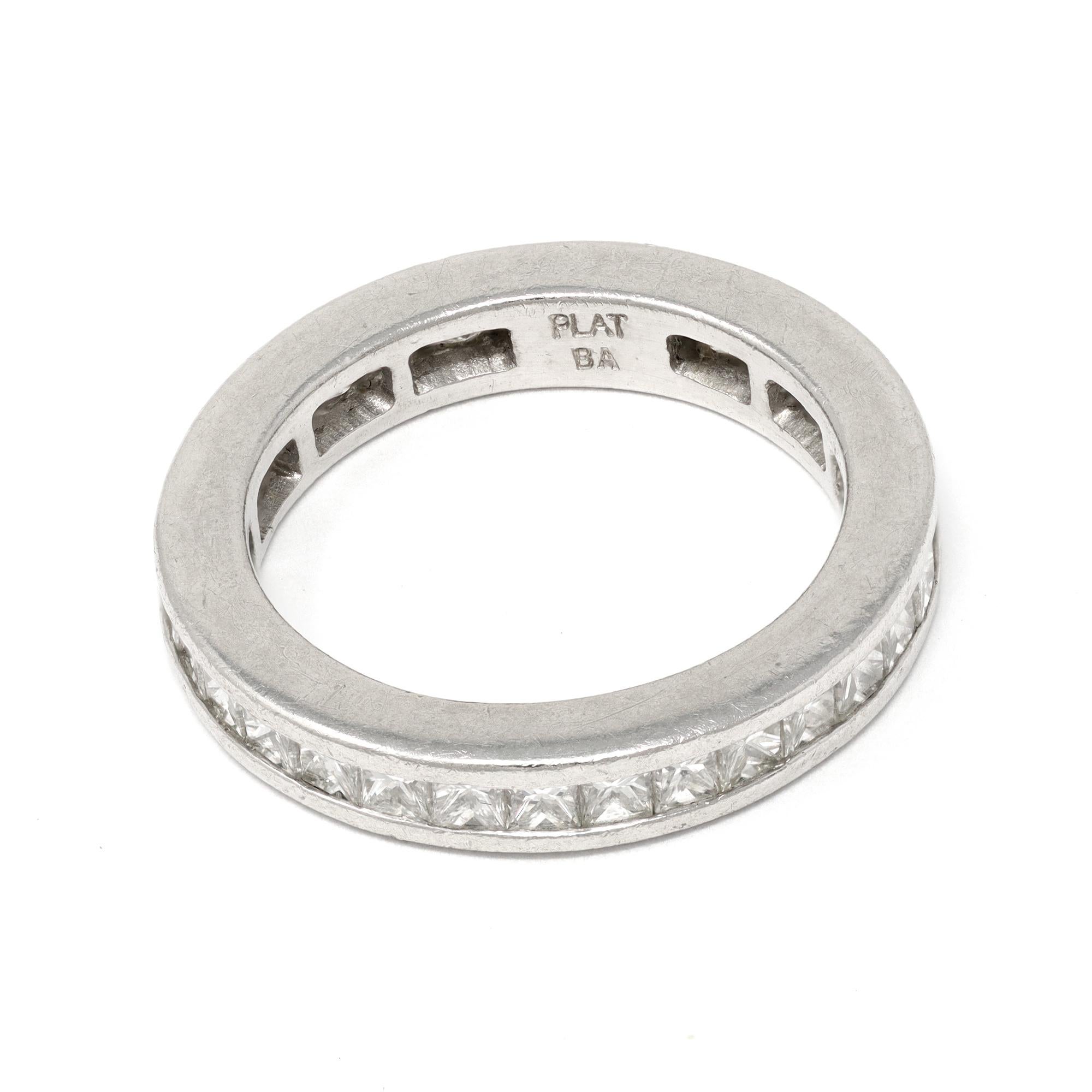 The eternity band features perfectly matching princess cut diamonds set in a channel fashion. The band was made in platinum circa 1990. The estimated weight and grade of the diamonds are 3 carats of GH color and VS clarity. The ring will fit a size