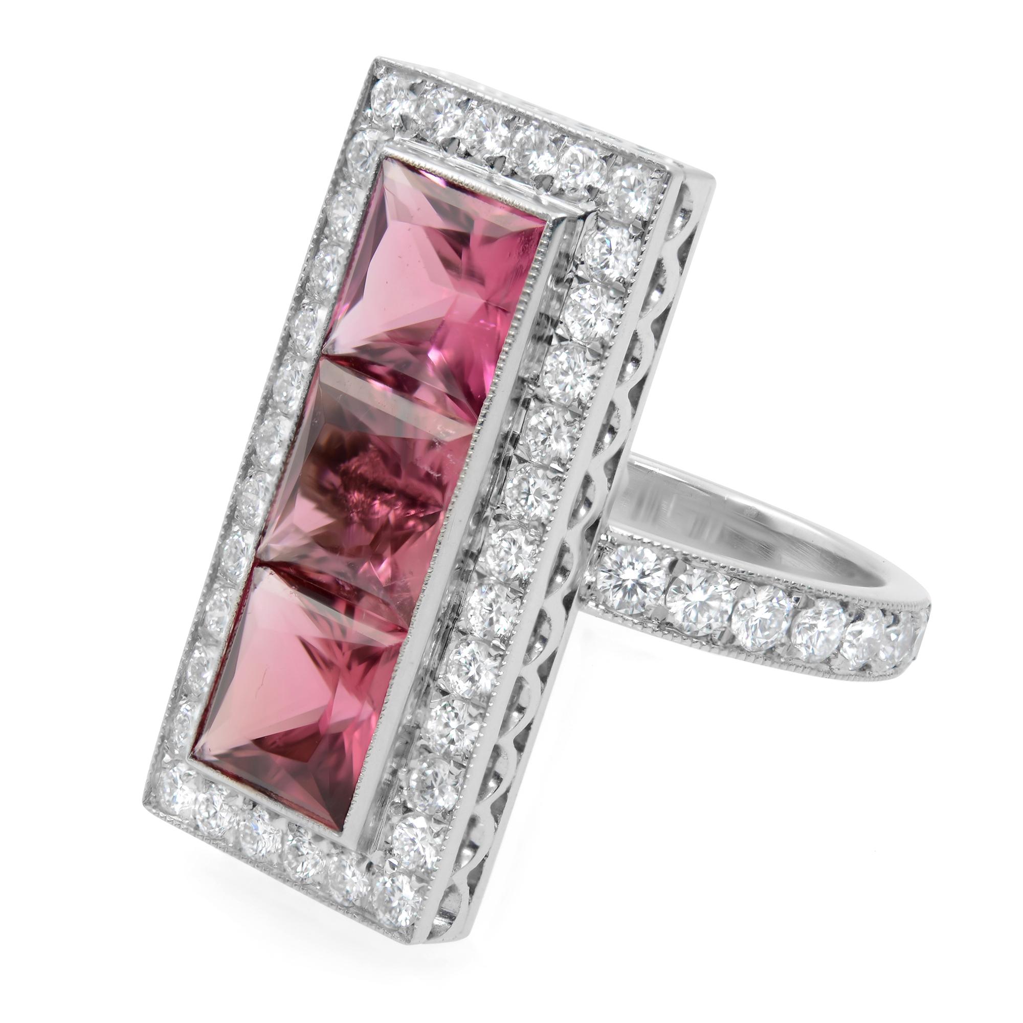 Exuding timeless glamour and luxury, this pink tourmaline halo ring is designed in platinum. A very unique design. Three princess cut, charming and bright pink tourmalines are bezel set with white diamond halo. The diamonds with their celestial