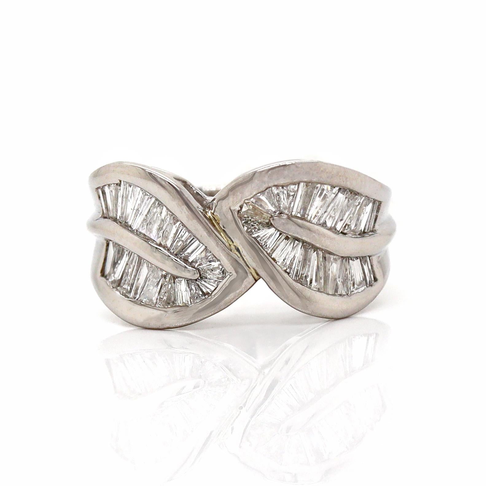 Platinum Pt900 Diamond Baguette Dress Ring

This elegant platinum ring features a unique and sophisticated design with two leaf-like figures crossing over each other, creating a beautifully flowing and dynamic shape. Each leaf is meticulously set