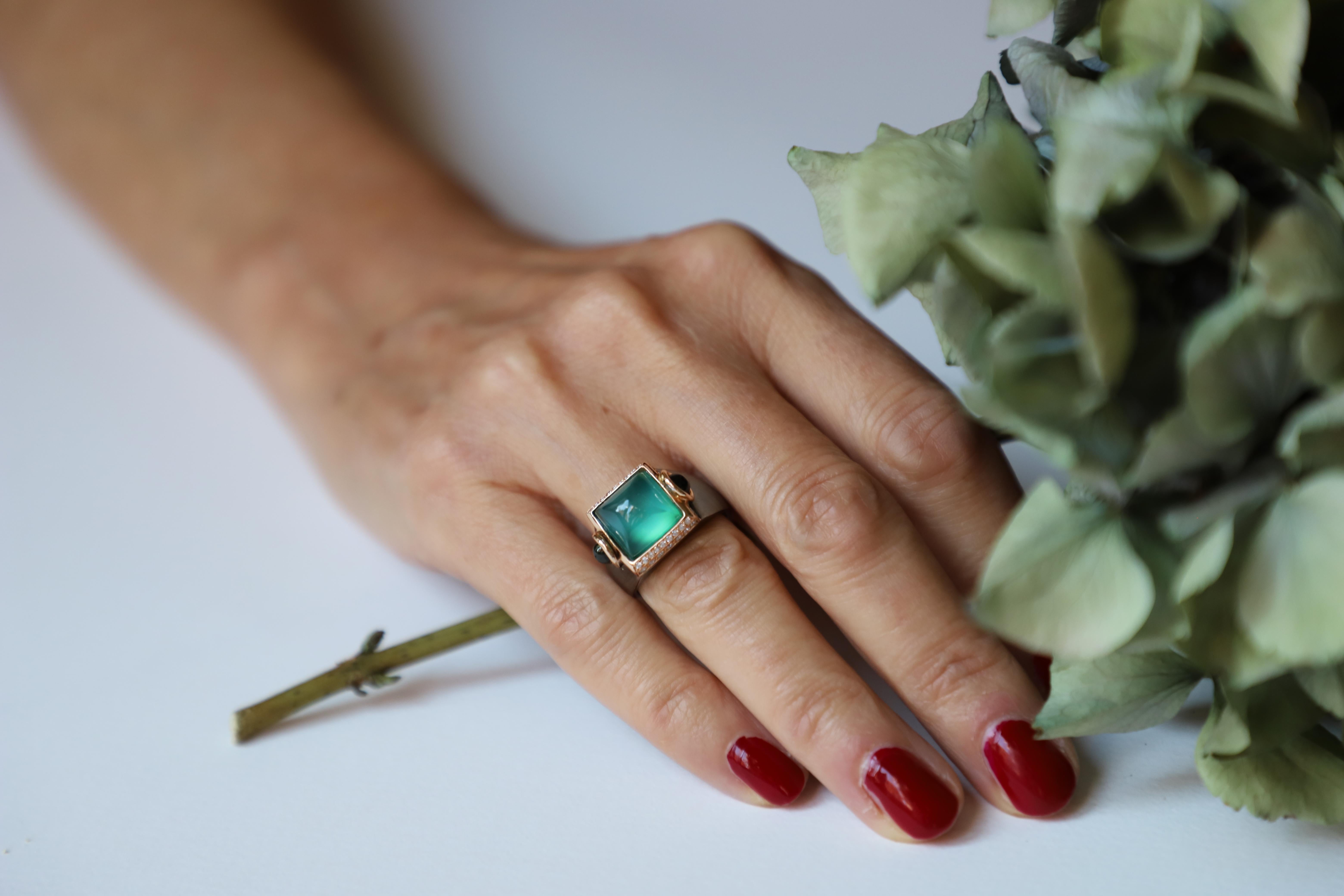 Unveiling Rossella Ugolini's Castle Collection: a magnificent fusion of Art Deco style and Italian heritage. This Platinum ring, adorned with 0.20 karat White Diamonds, showcases a captivating blend of Sugarloaf cut Green Agate and Green Cabochon