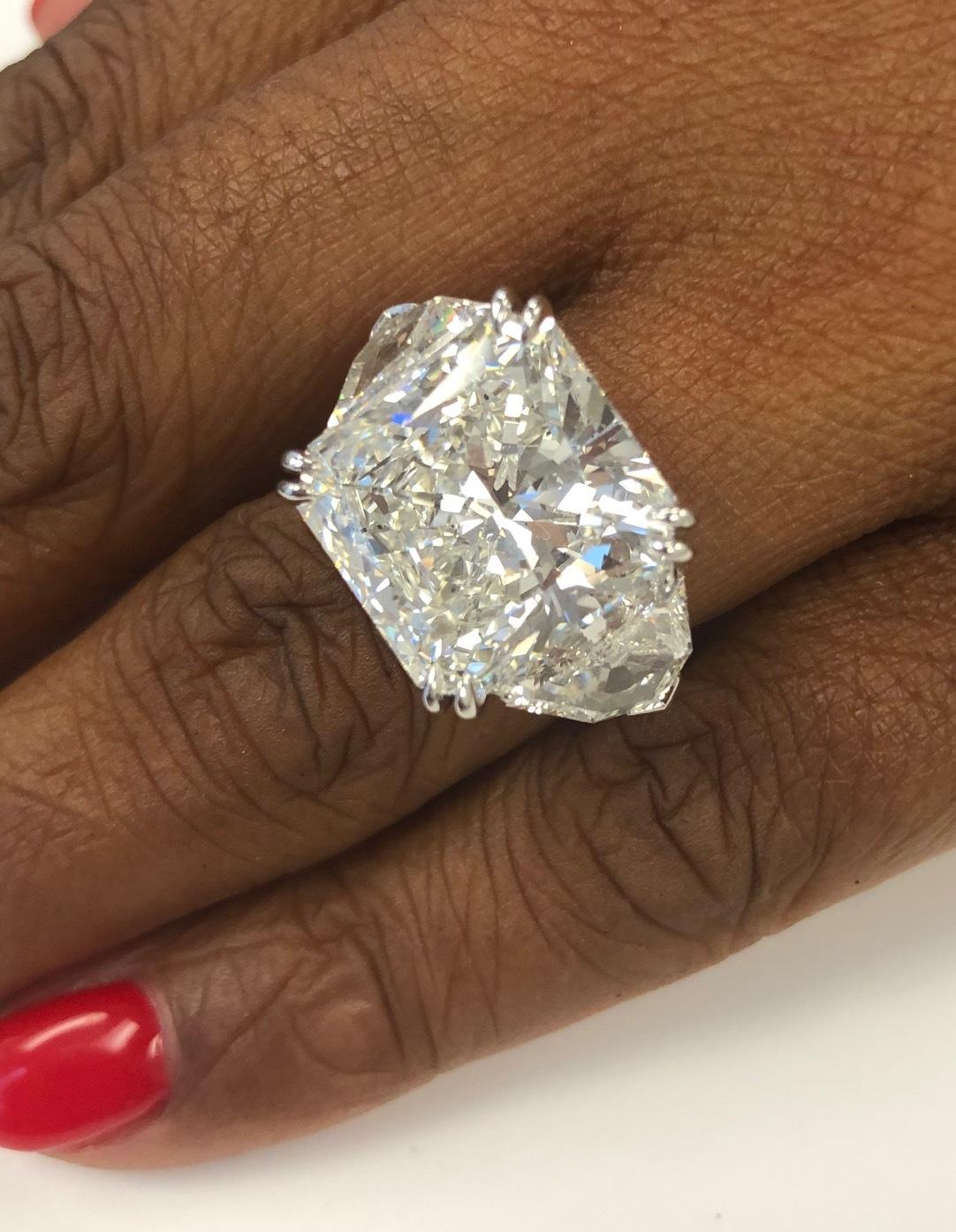 Spectacular Ring, totally Handmade in Platinum for this super brilliant Radiant Diamond of 12.62 carats with a GIA report HSI1 and a pair of perfectly matched sides, Shield shape Diamonds 2.25 carats.
The ring is made by our master jeweler and the