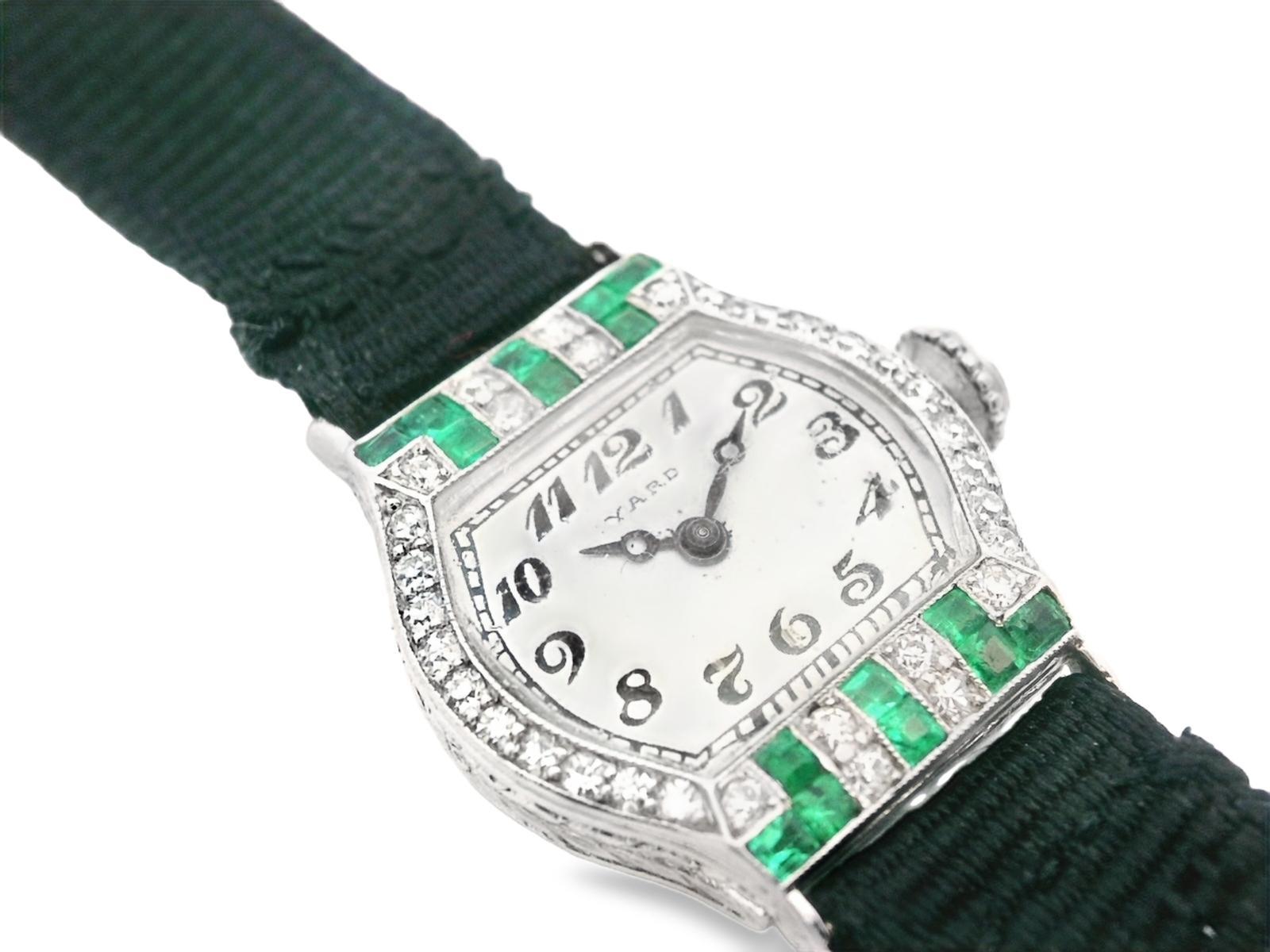 This exquisite platinum watch was made by the renowned Raymond Yard with both square cut emerald and round cut diamond. The watch face has a unique shape; the top and bottom of the case of the watch are flat, and both of the side walls are curved.