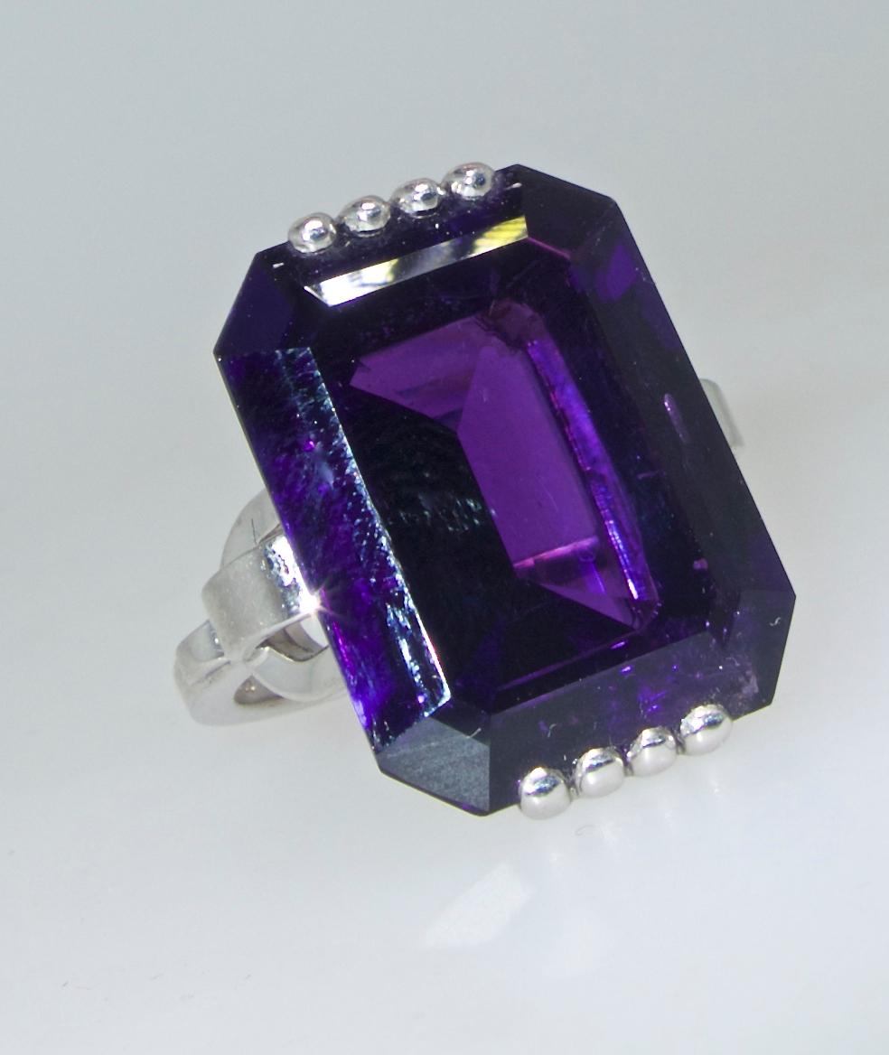Fine deep purple natural amethyst weighing 16.82 cts, displaying a bright deep purple color with red undertones, set in a geometric hand made platinum ring.  The ring is a size 6 and can be altered easily.  