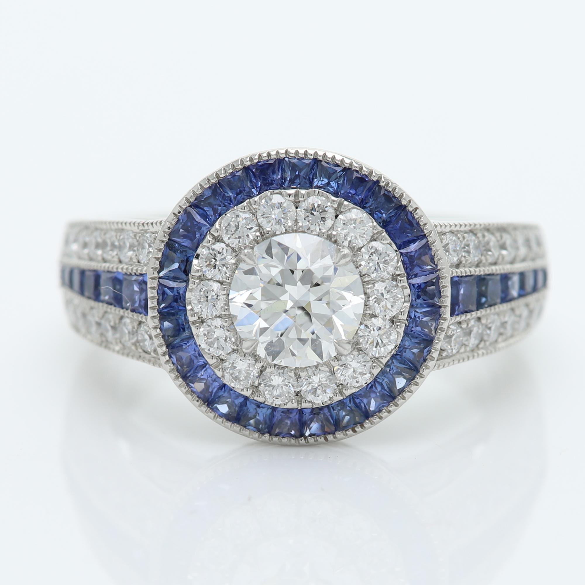 Art Deco Style Bold Ring
Center is 0.73 carat Diamond surrounded with Blue Sapphire, 
Center Diamond is a Brilliant D-VS2 (6.0 mm)
All stones are Natural
Platinum 13 grams
set in a cup setting
Small Diamonds 1.70 carat
Blue Sapphire 1.19
