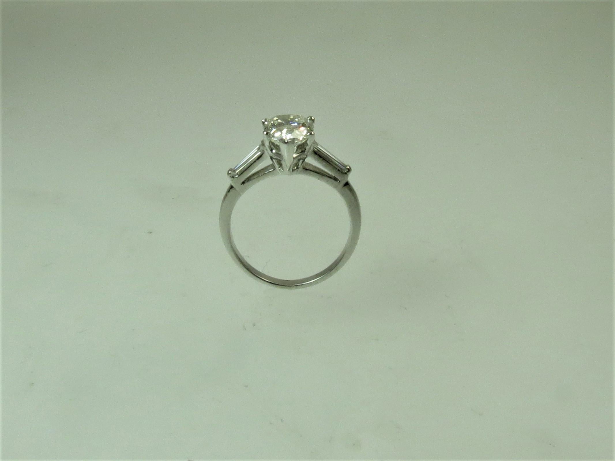 Round Cut Platinum Ring  Prong Set With Pear Shape Diamond Weighing 2.02cts and Baguettes For Sale