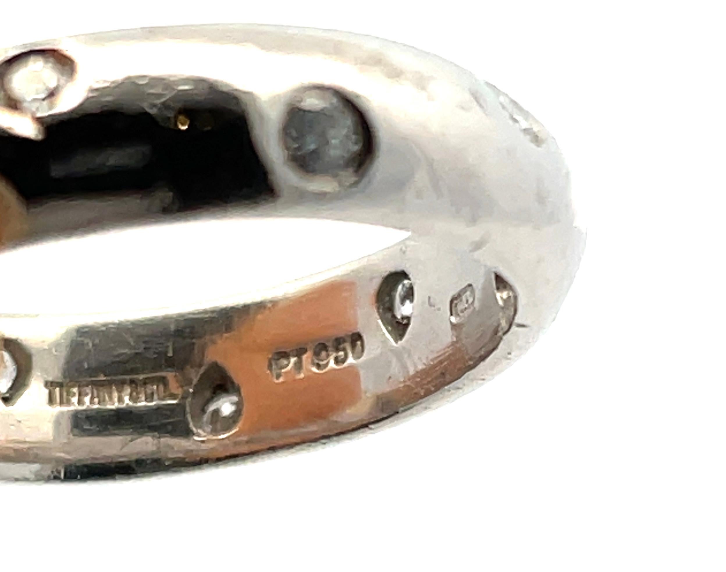 The **Tiffany & Co. Platinum Ring** is a luxurious, finely crafted piece made from high-quality platinum, known for its durability and timeless shine. The design is sleek and minimalist, featuring **10 diamonds with a total weight of 0.22 carats**,
