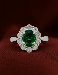 Platinum Ring with 1.56 carat Oval Emerald surrounded by Brilliant Diamonds
