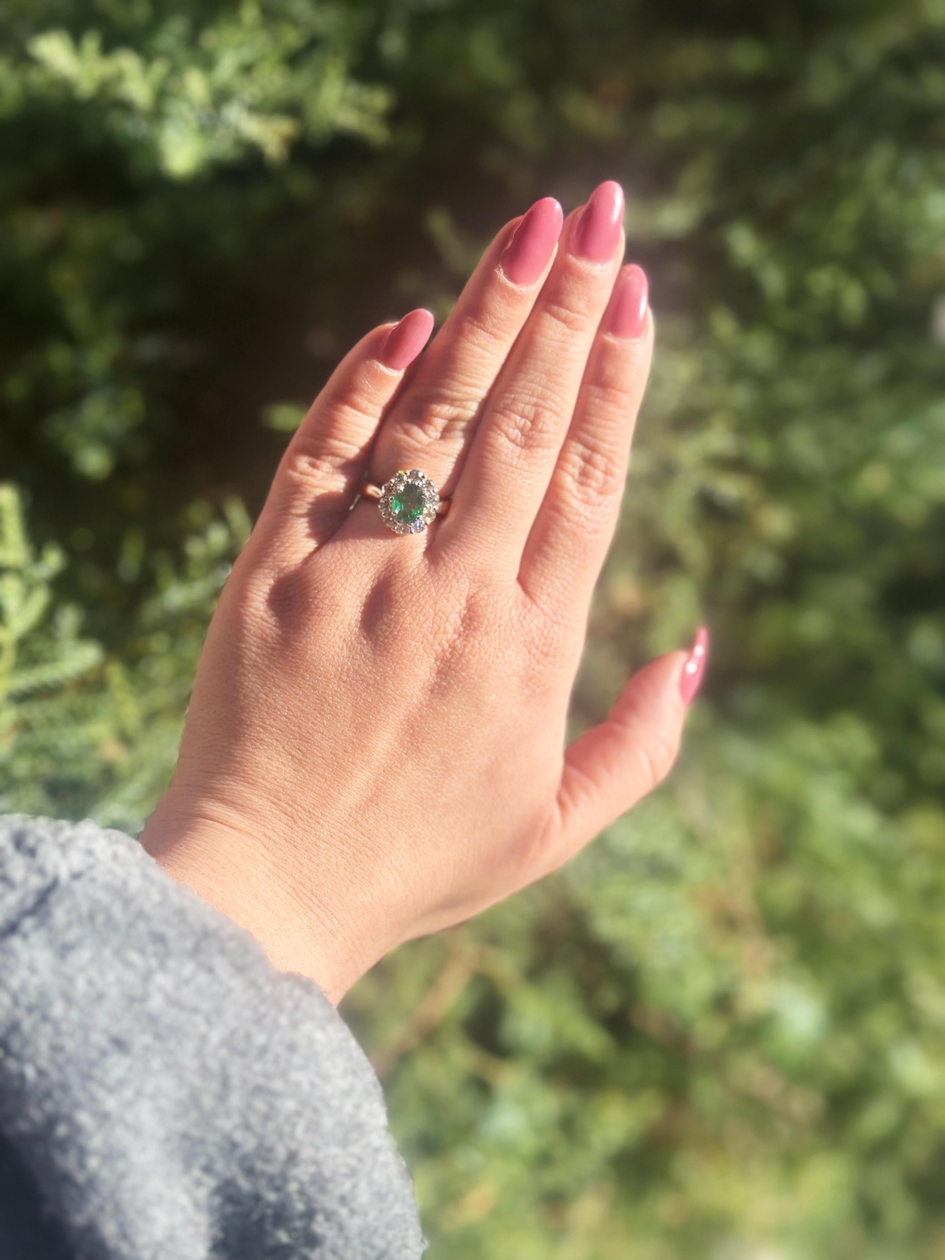 Modern Platinum Ring with 1.56 carat Oval Emerald surrounded by Brilliant Diamonds For Sale