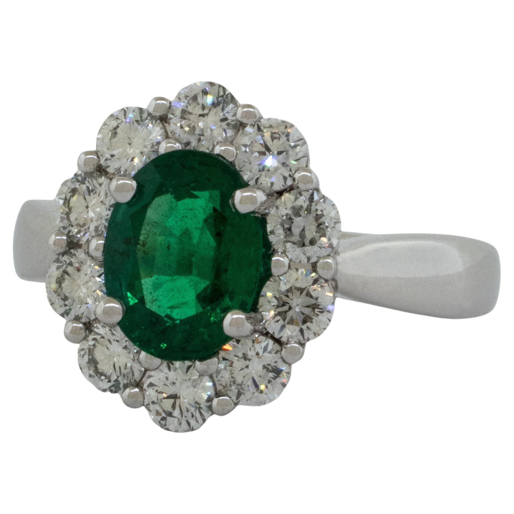 Platinum Ring with 1.56 carat Oval Emerald surrounded by Brilliant Diamonds