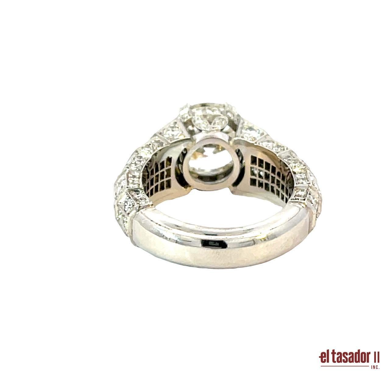 This exquisite platinum ring showcases a dazzling 4.05-carat round brilliant-cut diamond at its center, radiating unmatched brilliance and presence. Crafted in 10.8 grams of solid platinum, the piece is further adorned with 2.61 carats of smaller