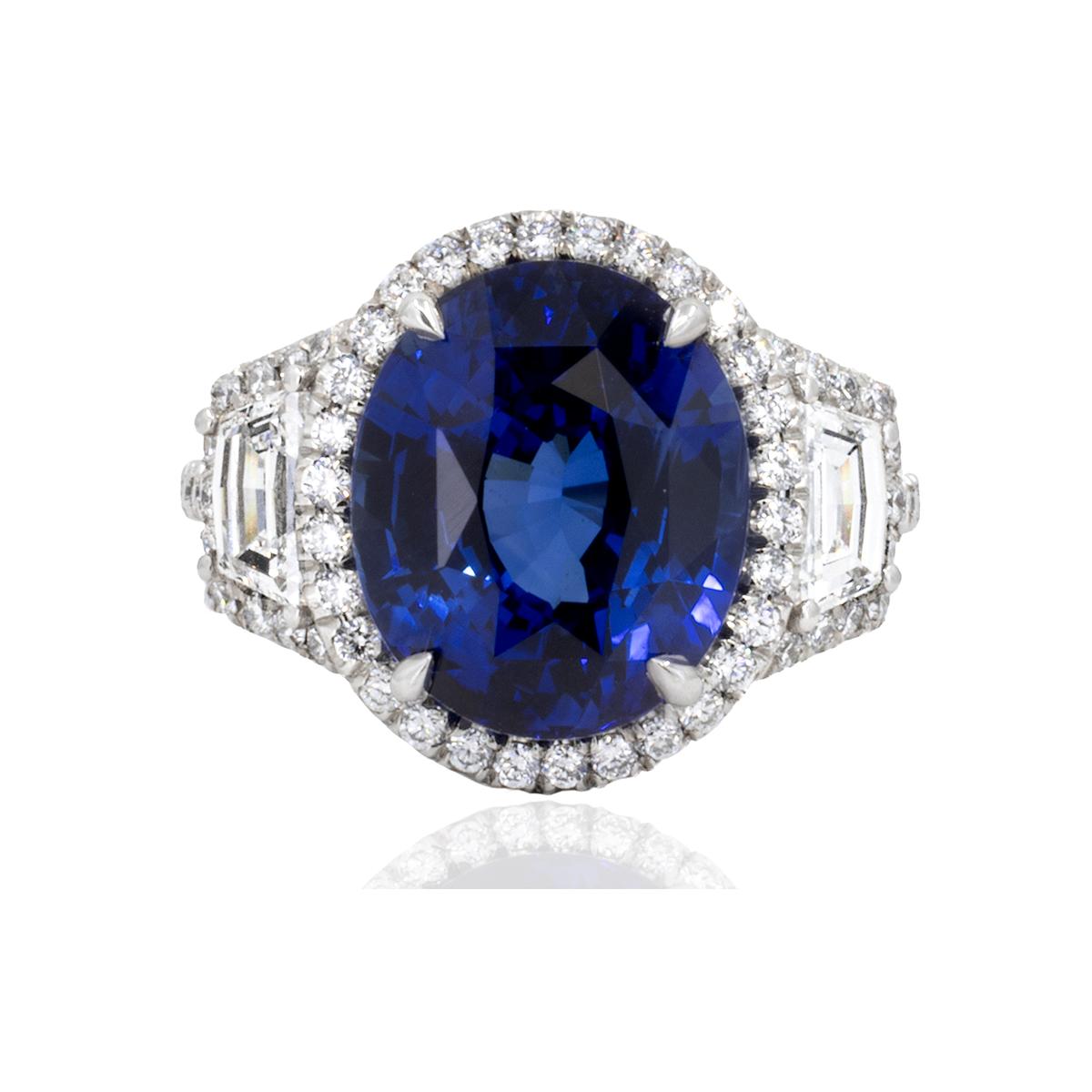 Platinum ring with GIA and GRS certified 9.56 carat, oval cut, Royal Blue Ceylon Sapphire, set with two trapezoid cut diamonds weighing 0.76 carats and 0.52 carats of round brilliant diamonds.