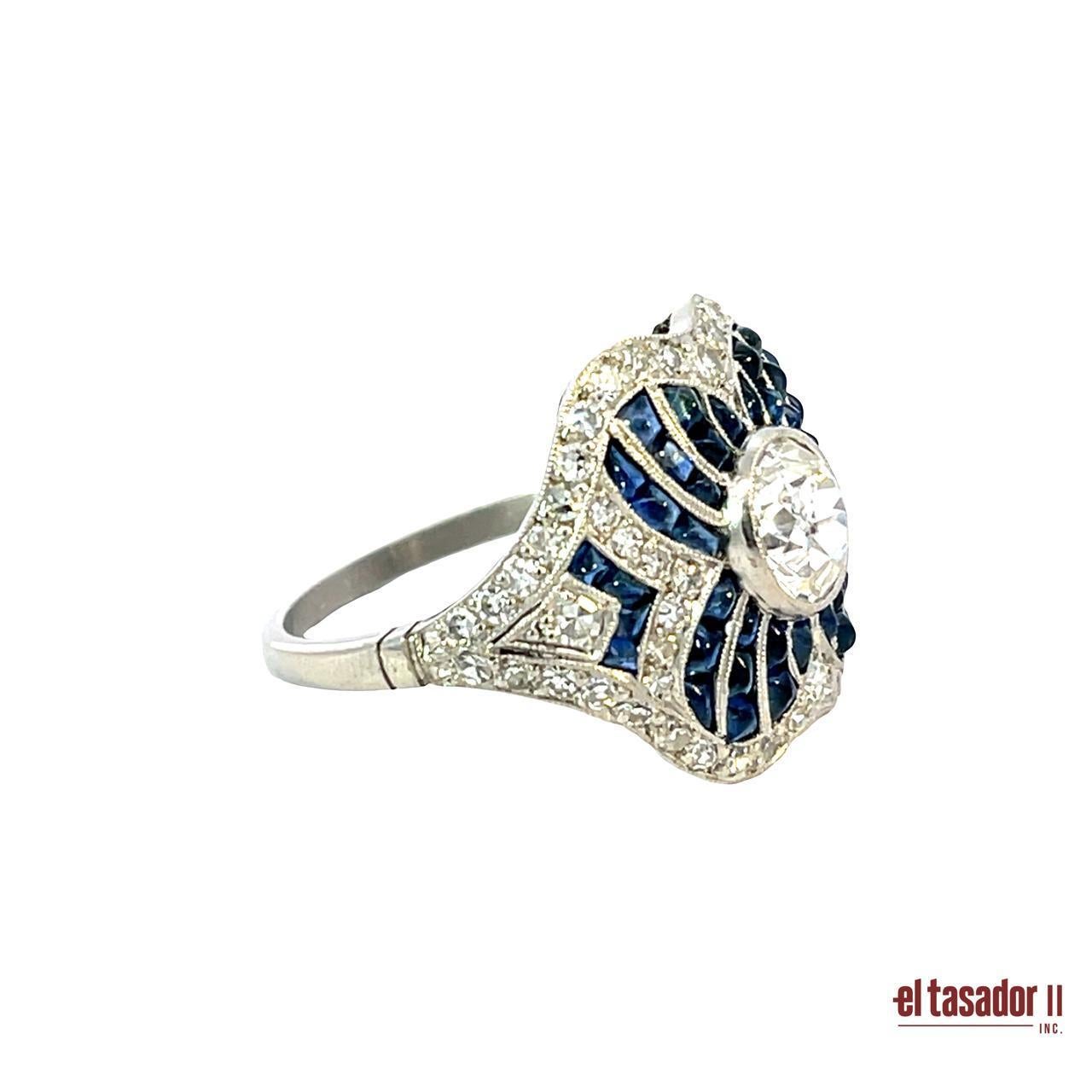 This stunning platinum ring, weighing 7.8 grams, features a 1.13-carat round brilliant-cut diamond at its center, surrounded by an exquisite floral pattern of 4.45 carats of deep blue sapphires. The elegant design is further enhanced by 0.59 carats