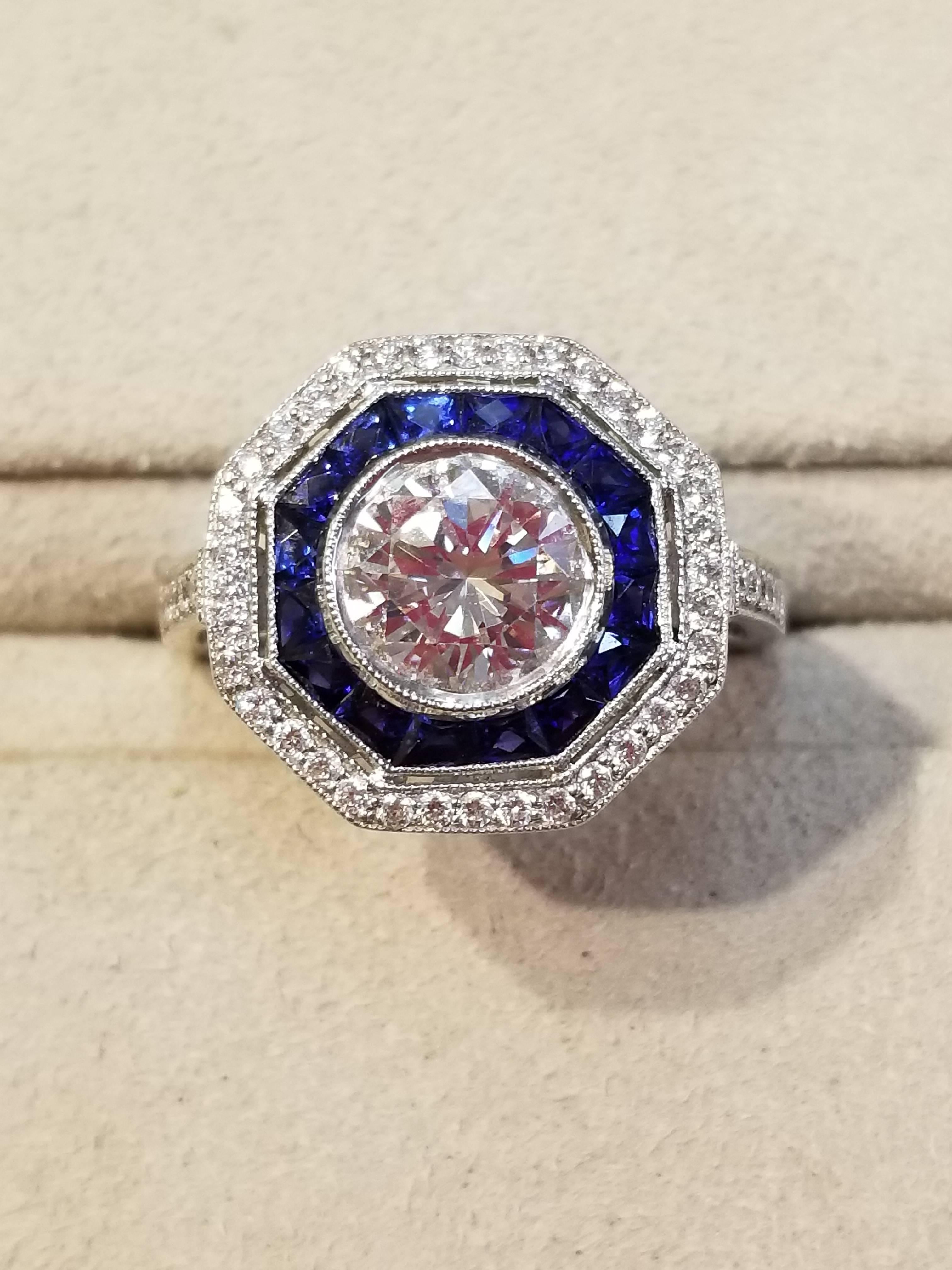Platinum ring with diamonds and sapphires, size 6 3/4. The center diamond is 1.47 carats, E color with a VS1 clarity and is EGL certified (EGL US59615301D). The surrounding 46 diamonds total 0.3 carats and are G-H color and VS clarity. The sapphires