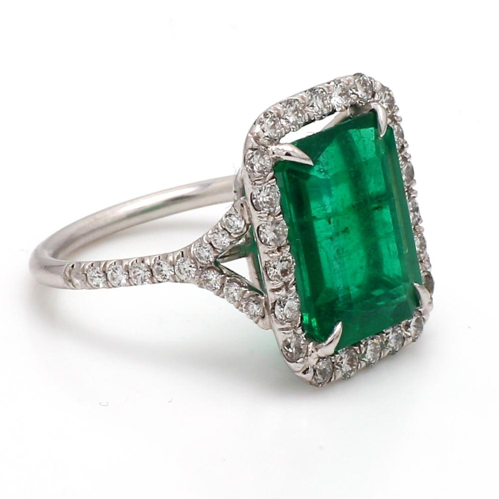 Platinum Ring with Emerald Cut Emerald and Diamond Accents

This luxurious platinum ring features a 5.93ct emerald cut emerald, beautifully accented by 1.24ct round brilliant diamonds. Weighing 6.4 grams and sized at 6.5, this resizable piece