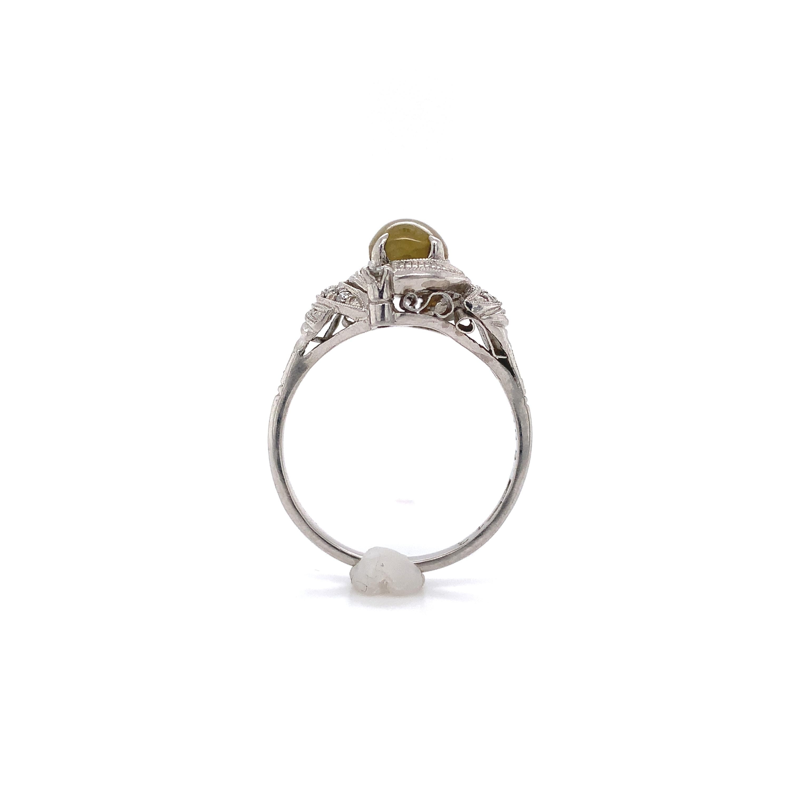 Platinum vintage ring featuring an oval natural cat's eye chrysoberyl weighing 2.05 carats with GIA report. Very pretty mounting with milgrain and hand made filigree wirework. The report #2225447568 states natural chrysoberyl with brownish yellow
