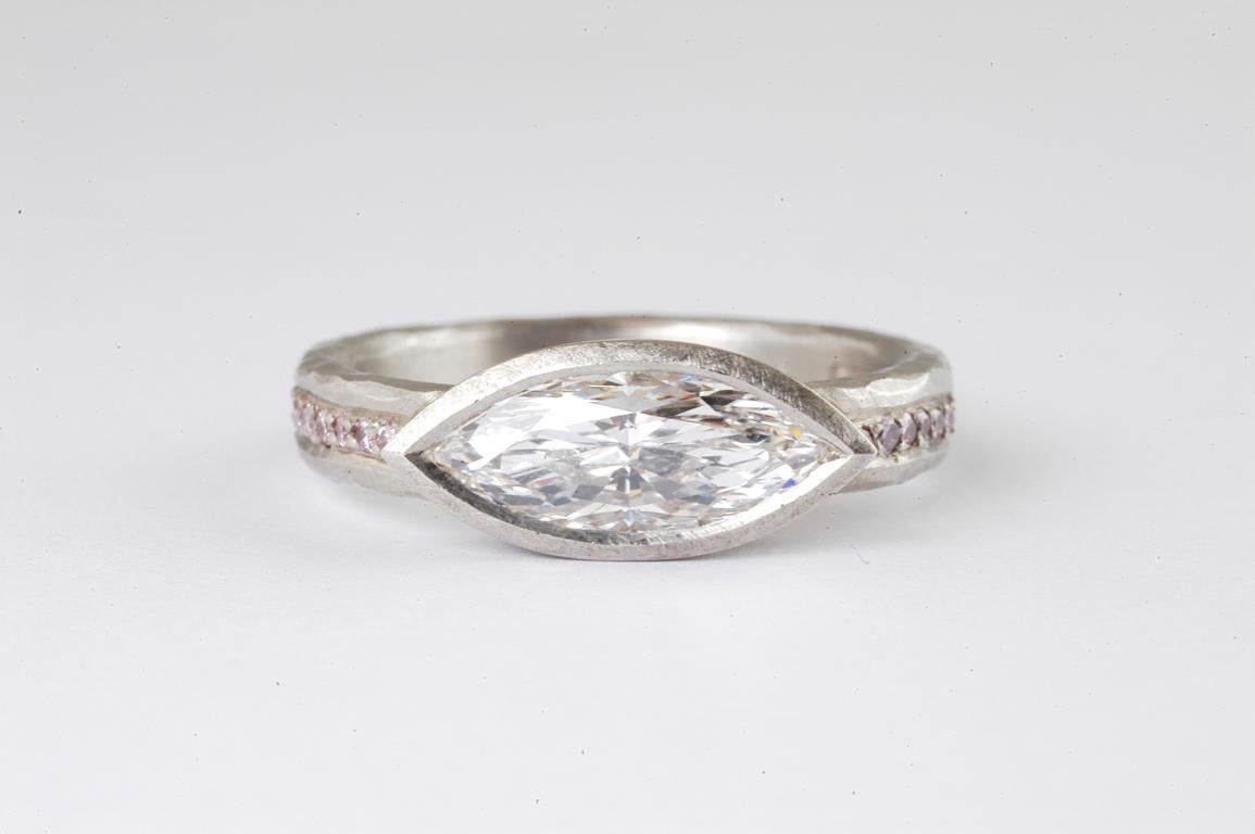 Platinum ring with marquise diamond 1.39cts and channel set natural pink diamonds - GIA Certified diamond F colour VVS clarity, handmade in Notting Hill London by renowned British jewellery designer Malcolm Betts.
Full eternity band in hammered