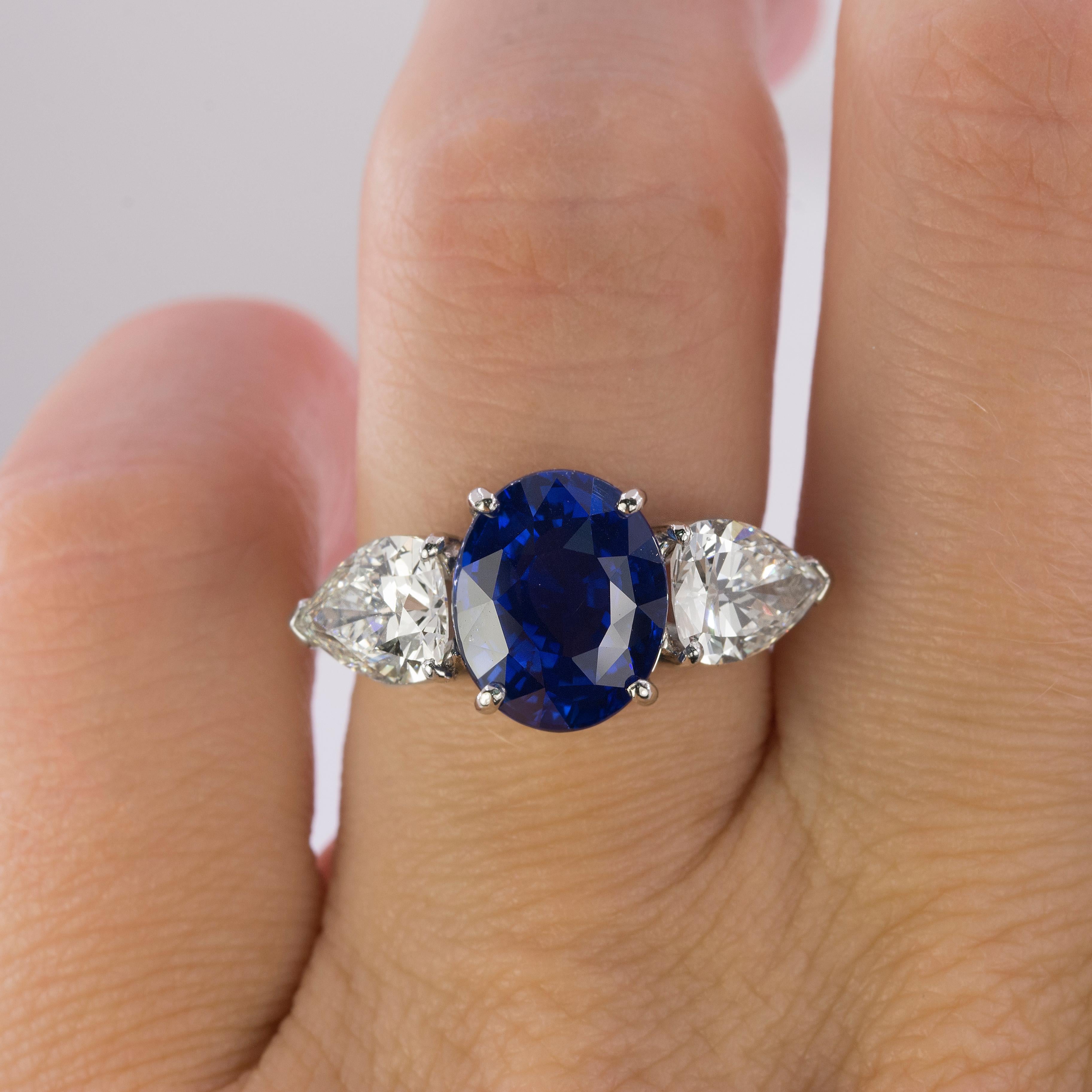 Magnificent GIA certified 5.51 carat Royal Blue Ceylon Sapphire set in hand fabricated platinum ring with two pear shape diamonds weighing 2.51 carats total weight.