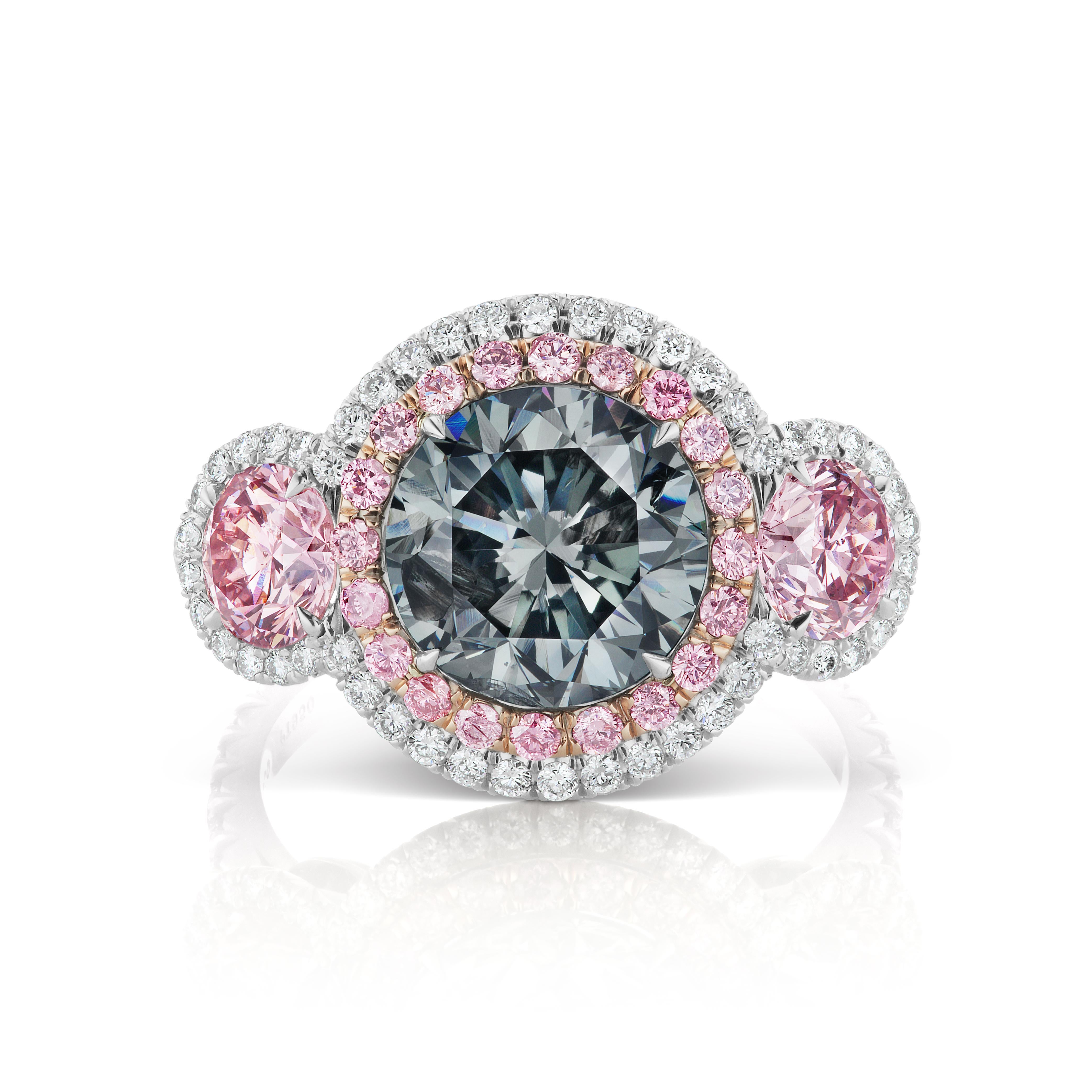 We are pleased to offer this Rare Ladies Platinum & 18k Rose Gold GIA Certified Fancy Blue-Gray & Fancy Intense Purplish Pink Diamond 3 Stone Ring. This stunning ring features a 3.03ct natural fancy blue-gray round brilliant cut diamond center stone