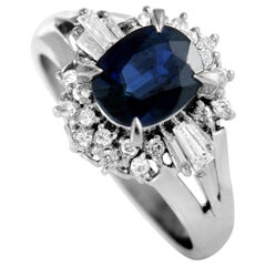 Platinum Round and Tapered Baguette Diamonds and Blue Sapphire Oval Ring