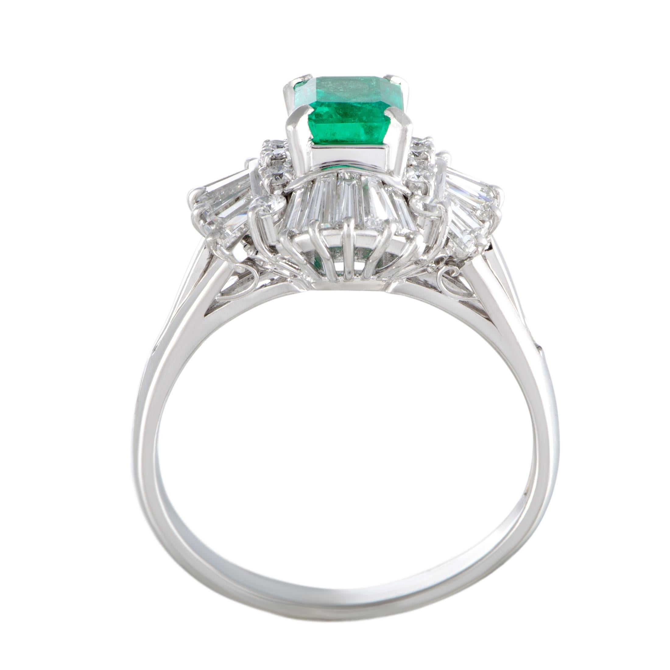 Splendidly decorated with resplendent diamonds and with a stunning emerald that are beautifully set against the elegantly gleaming platinum, this spectacular ring boasts a remarkably extravagant appeal. The emerald weighs 1.16 carats and the
