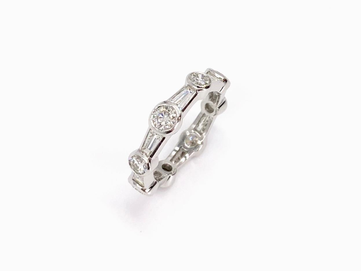 Beautifully modern platinum eternity diamond band featuring bezel set round brilliant and tapered baguette diamonds at 2.45 carats total weight. Ring is expertly designed by Alex Primak - now Sasha Primak Company using diamonds of approximately F-G