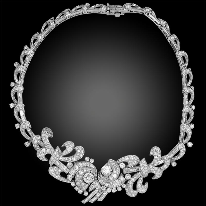Comprising an intricately crafted 1960s necklace of asymmetrical scroll design, set with an opulence of round and baguette cut diamonds finely mounted in platinum gold arabesques, measuring approximately 14 inches in length with diamonds weighing