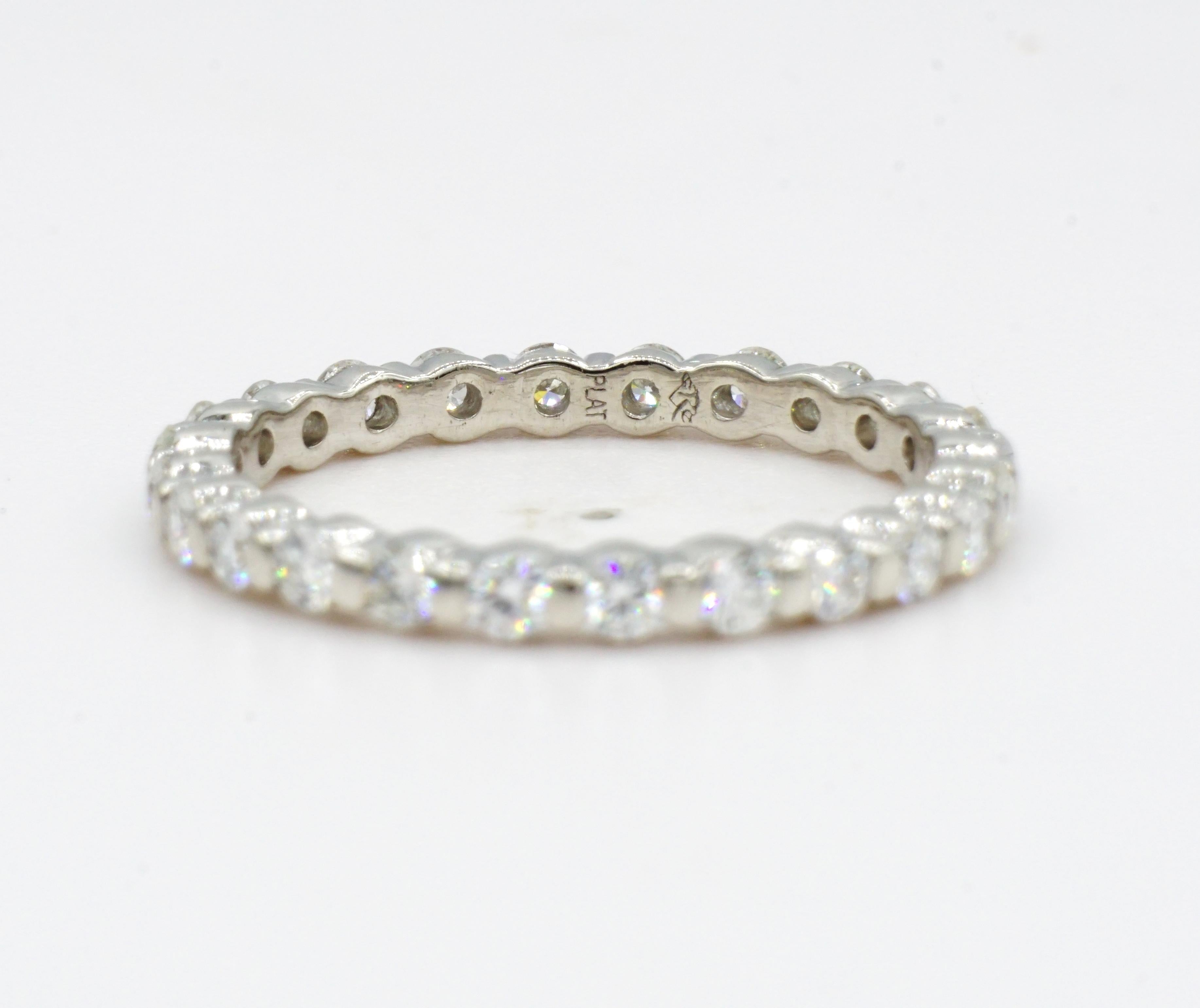 Beautiful platinum round brilliant diamond eternity ring with twenty-four diamonds of .75cttw. The channel set diamonds are colorless, VS in clarity, and have an excellent cut. This ring is size 6, 950 platinum, and weighs 2.9g grams. Designed and