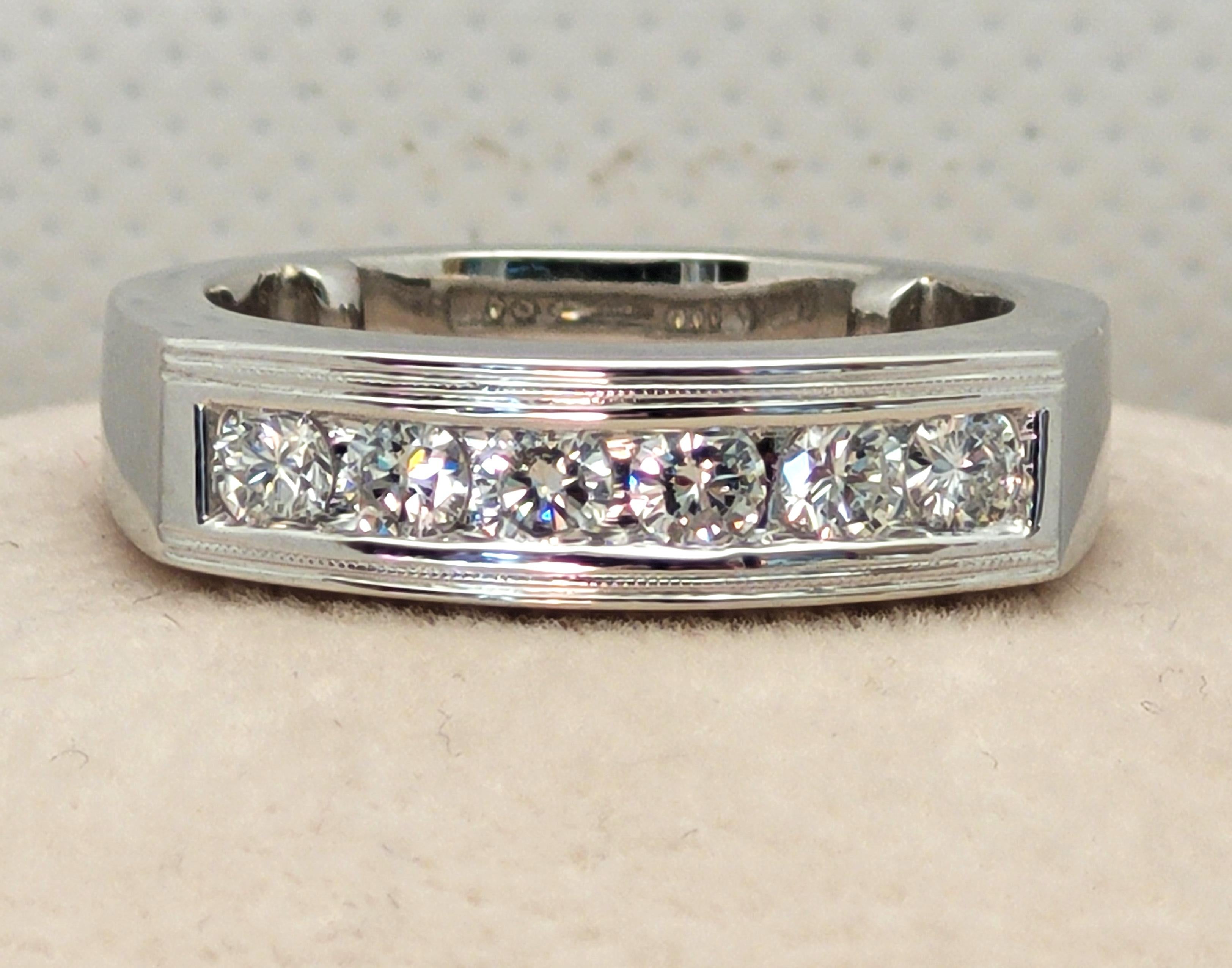 Platinum round brilliant diamond ring with .48cttw in diamonds. The diamonds are collection quality, F/G in color, SI/VS in clarity,  and channel set. The ring has a squared-off top, detail with miligrain, and inside the ring are two platinum shank