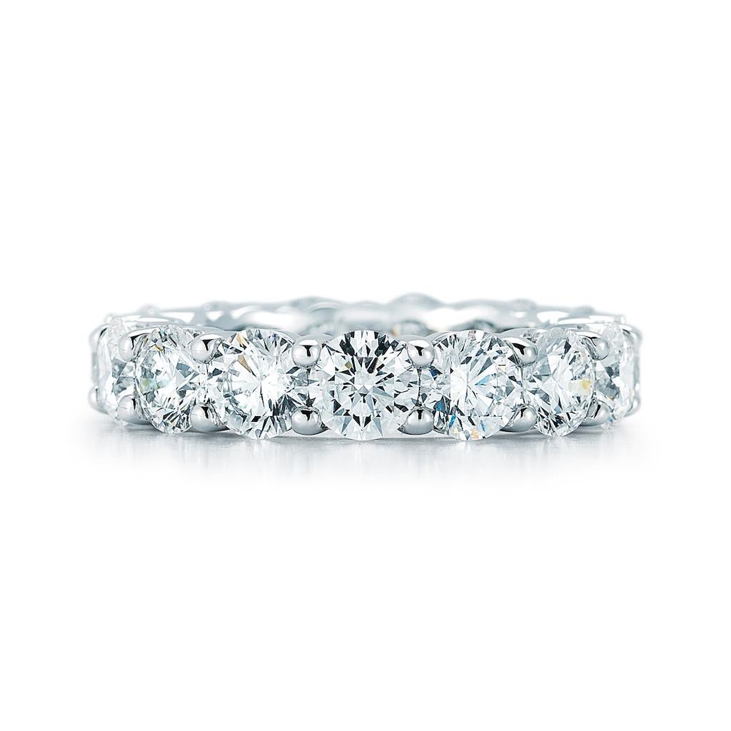 This is a superb, newly-crafted diamond eternity band rendered in rich platinum. Fourteen perfectly matched high-color, high-clarity round brilliant-cut diamonds, totaling 7.00 carat, are each set individually within four secure prongs. This is a