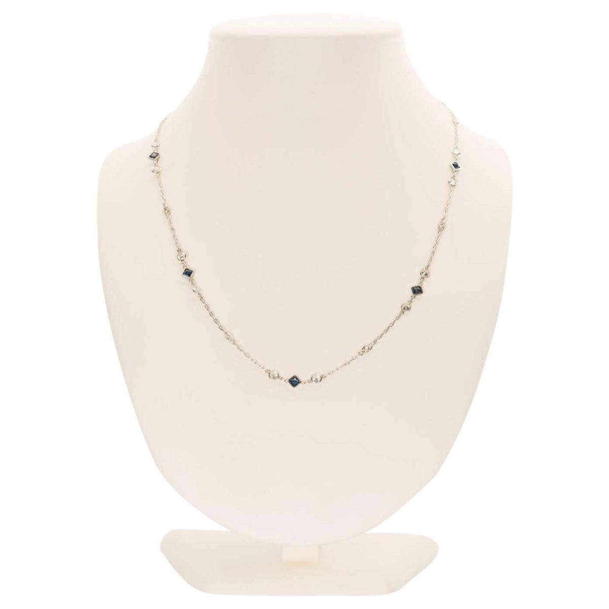 Perfect for every occasion, this subtle yet timeless necklace is set with 14 bezel set brilliant cut white diamonds weighing approximately 1.40 carats alongside 7 square cut blue sapphires weighing approximately 1.10 carats. The chain is a fine