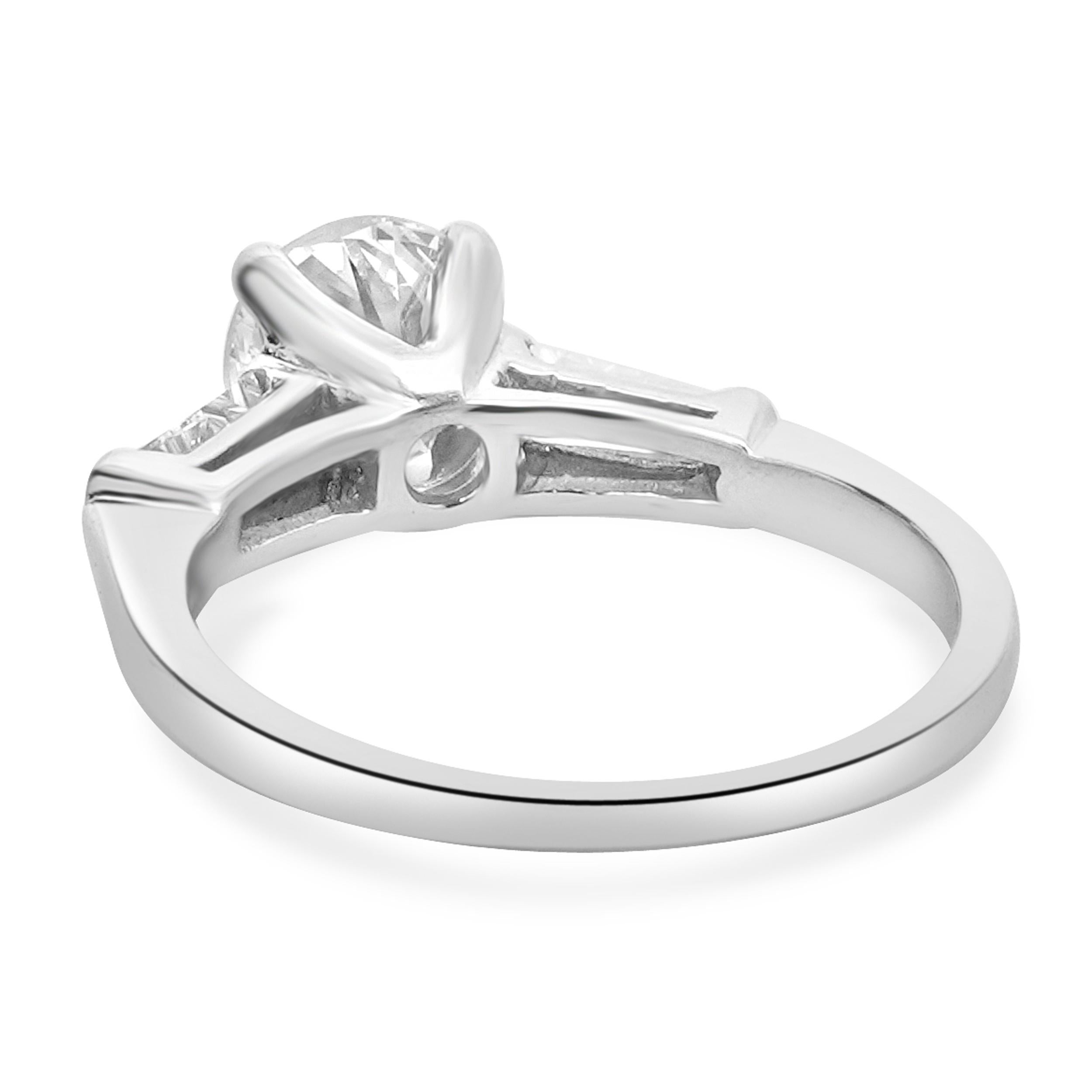 Designer: custom
Material: Platinum
Diamond: 1.05cttw
Color: J
Clarity: SI1
Diamonds: 2 tapered baguette diamonds= 0.30cttw
Color: J
Clarity: VS2
Ring Size: 5.75 (please allow two additional shipping days for sizing requests)
Dimensions: ring top