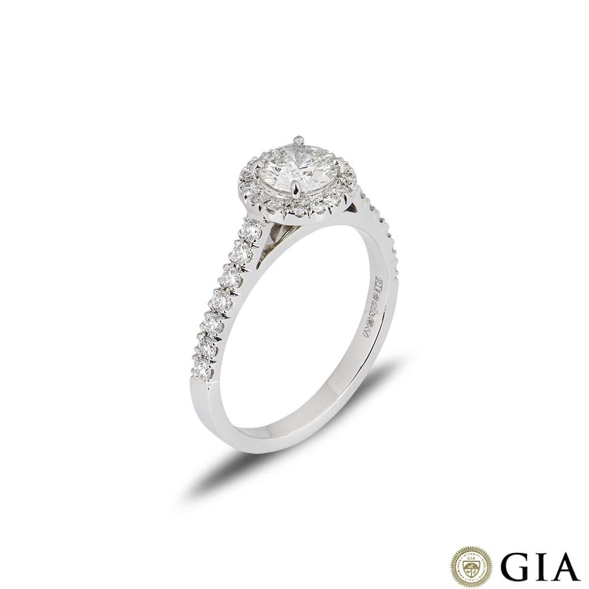 A beautiful diamond ring in platinum. The ring is set with a natural very light green round brilliant cut diamond, which is SI1 in clarity. The ring has diamond set shoulders and a diamond halo totalling approximately 0.40 carat. The ring is