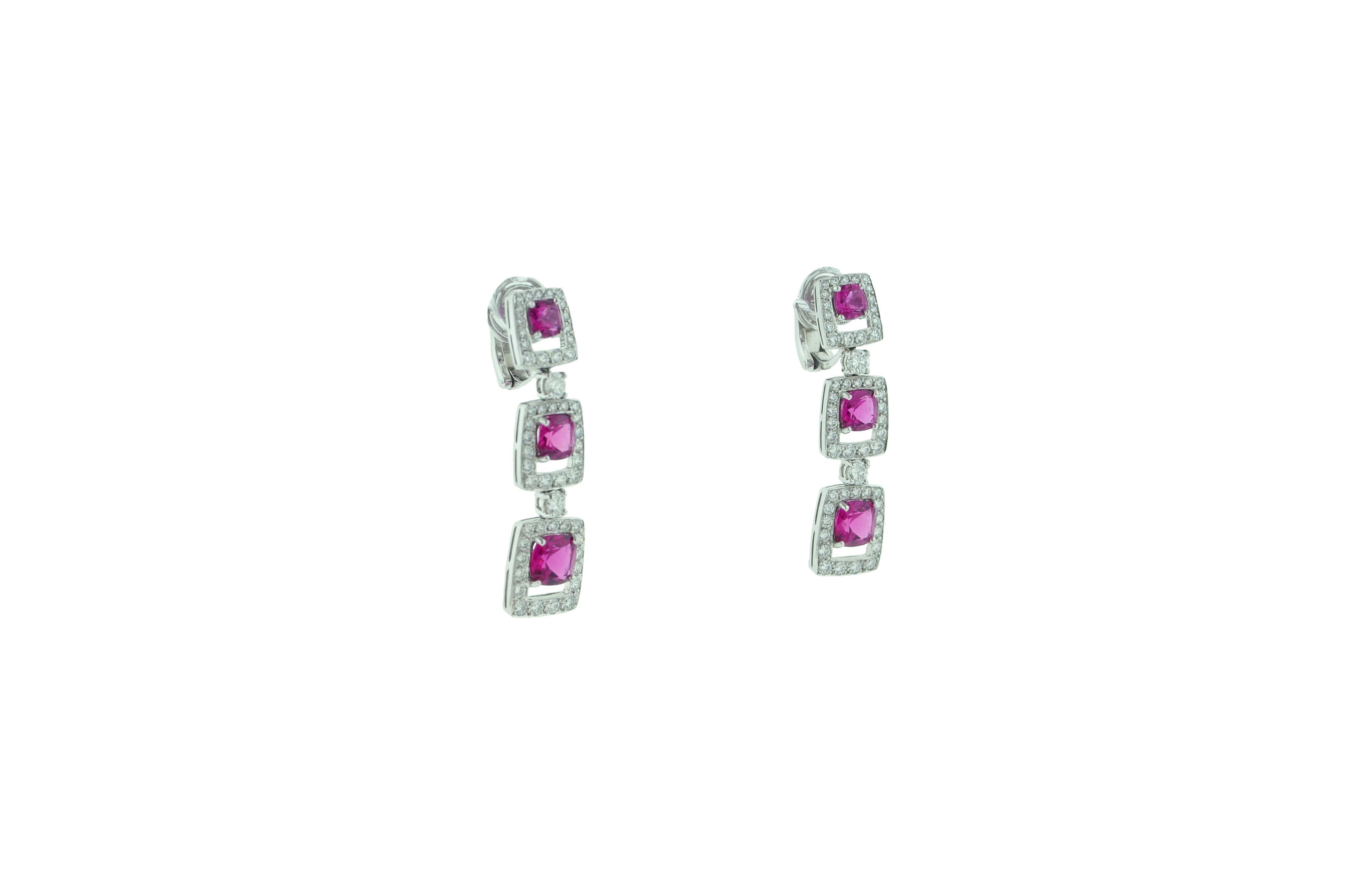 These rubellite and diamond earrings feature six rubellites that have a total weight of 6.12 carats. 

These vivid pinkish-red rubellites are framed in with diamonds that total 2.85 carats. 

Crafted in platinum these gorgeous earrings are mounted