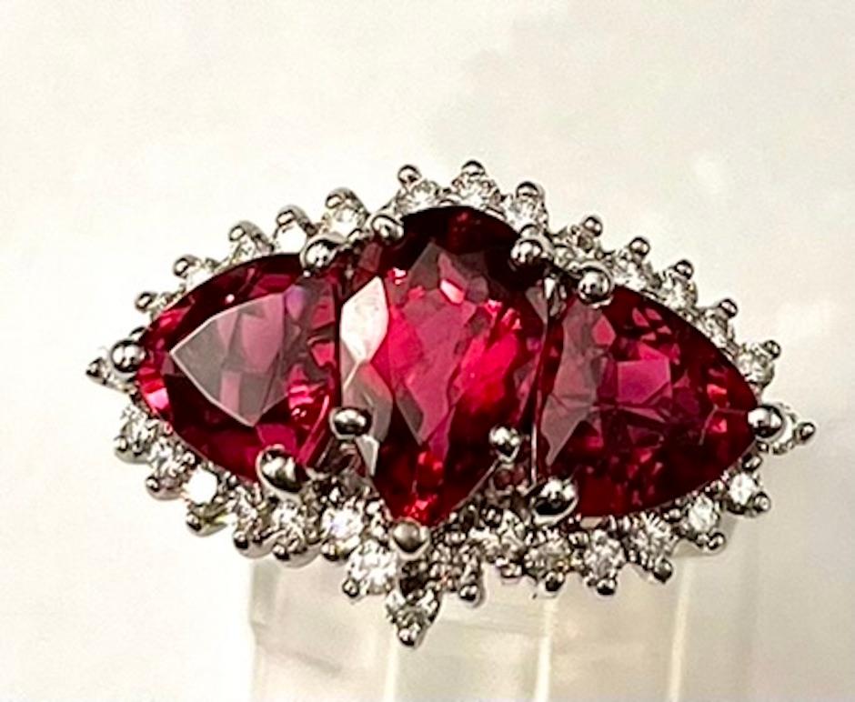 This is a very regal Rubellite Tourmaline ring set with 3 Top Gem Quality Rubellite Tourmalines of 5.50Ct Total Weight -- one Pear Shape and 2 Triangle Cut. The intensity of color is unmatched and does not get any better. These Rubellite Tourmalines