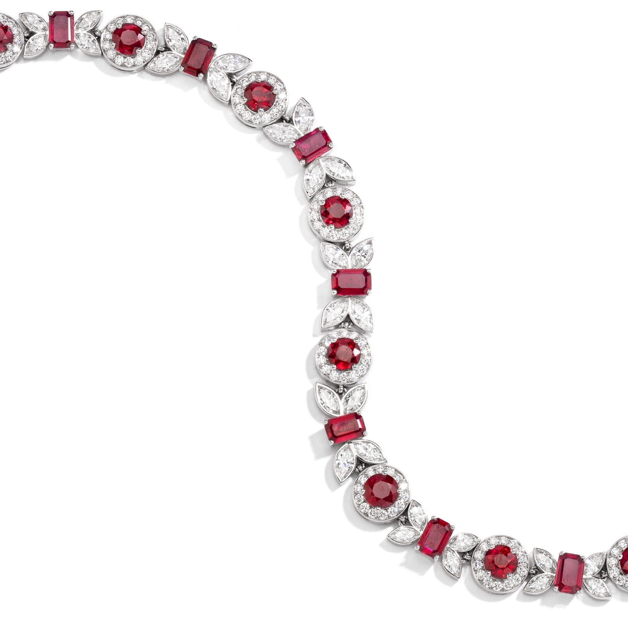 A platinum (PT950), ruby, and diamond bracelet of floral design, with round and emerald cut rubies weighing a total of 10.12 carats, and diamonds weighing a total of approximately 1.39 carats. The rubies are a very fine red hue showing medium to