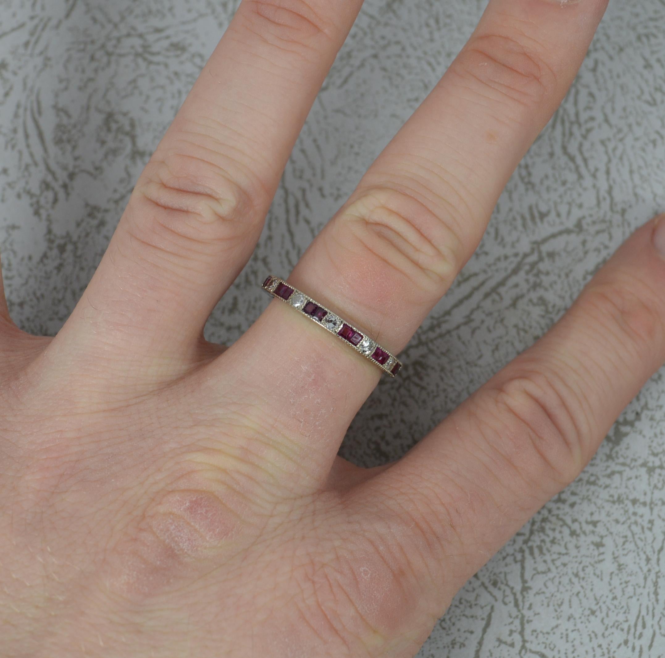 Platinum, Ruby and Diamond ladies full eternity stack ring. c1920.
Solid platinum example throughout. 2.5mm wide, 2.0mm off the finger,
Set with alternating pairs of princess cut ruby stones and round cut diamonds in fine grain settings.

Condition;