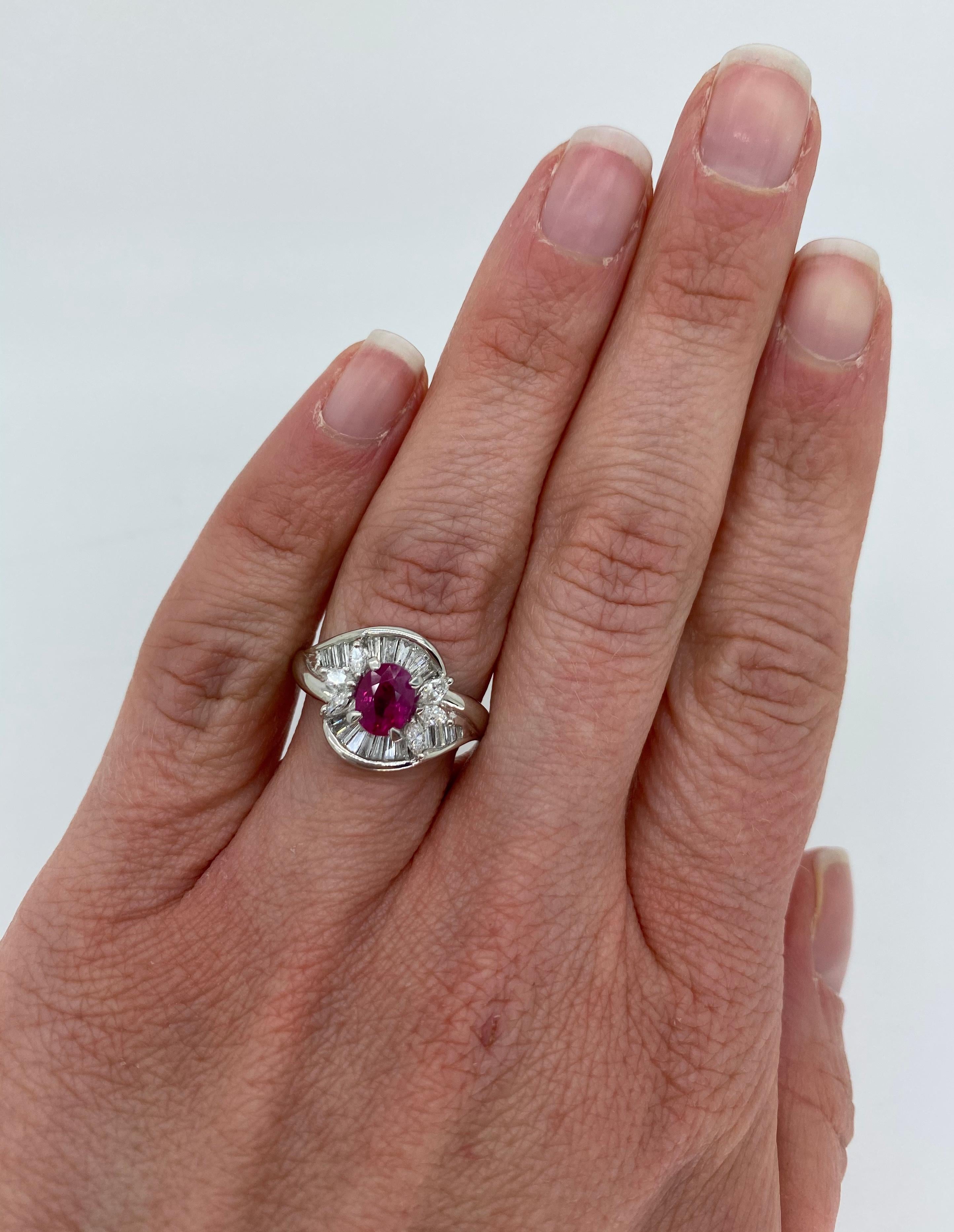 Cross over halo style Diamond and Ruby cocktail ring crafted in platinum.

Gemstone: Ruby & Diamond
Gemstone Carat Weight: Oval Cut Approximately 1.08CT Ruby
Diamond Carat Weight: Approximately .45CTW 
Diamond Cut: Marquise Cut and Tapered Baguette