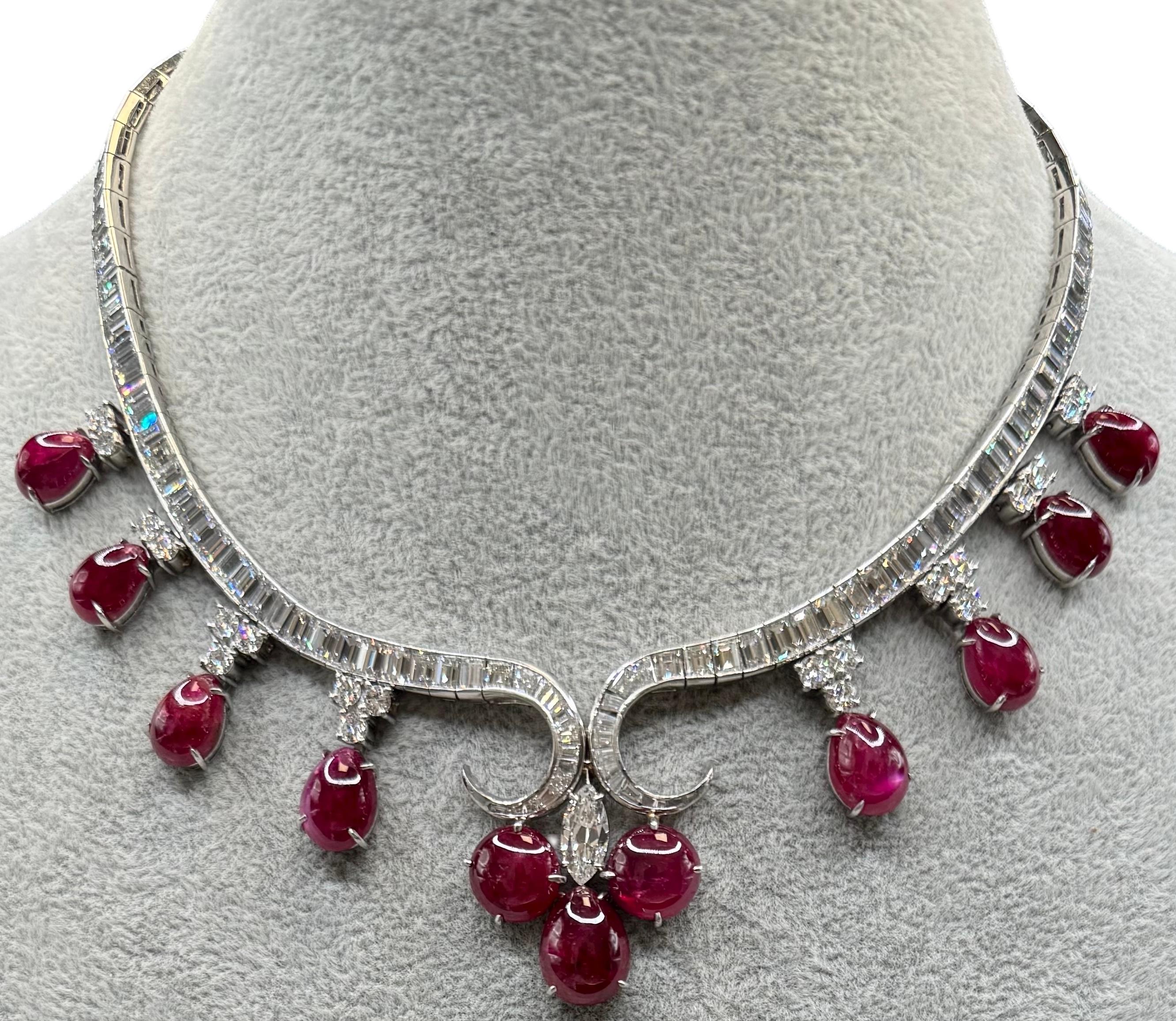 An extraordinary high jewelry platinum necklace showcasing a magnificent suite of 11 cabochon rubies totaling approximately 56.73 carats. Each ruby is rich in saturation and arranged as elegant drop clusters designed to catch light with