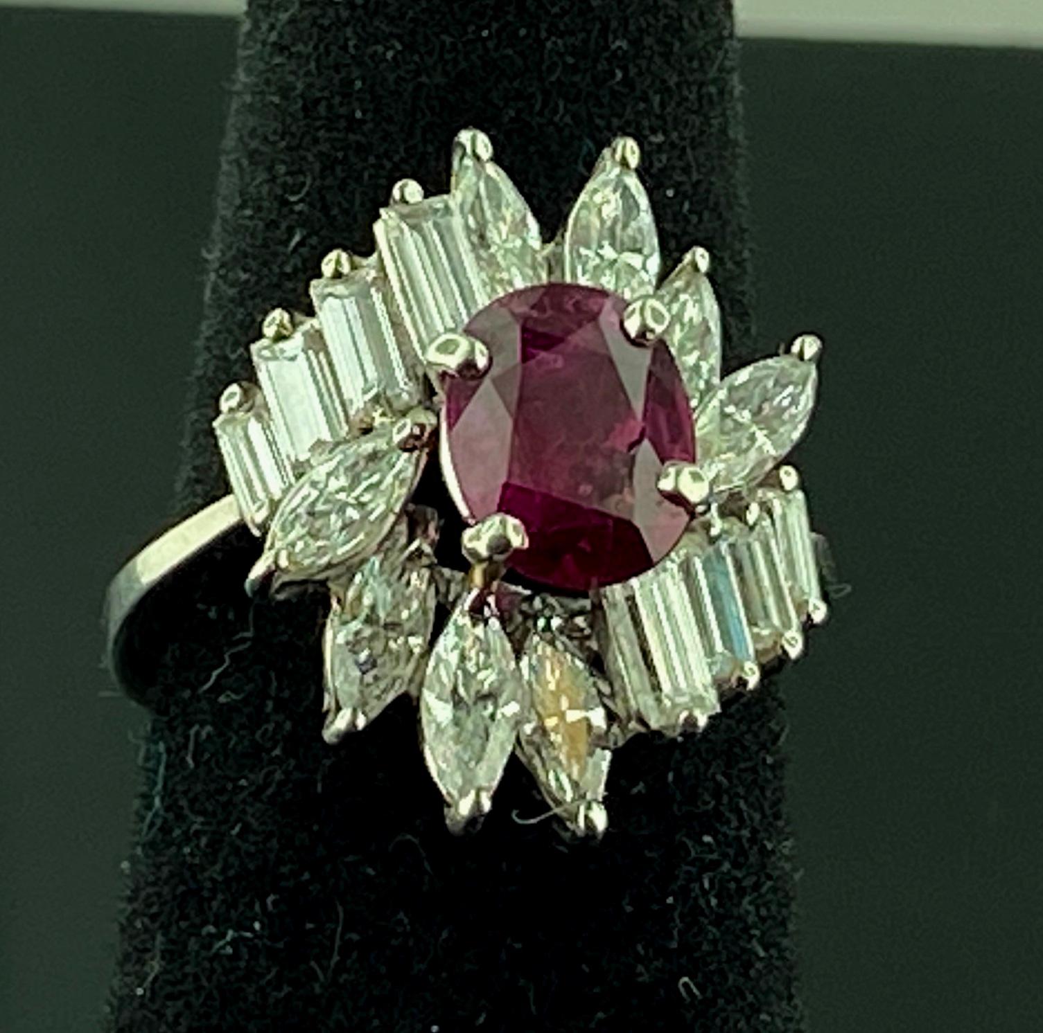 Set in Platinum is an Oval cut 1.00 carat Ruby in the center, surrounded with 8 Marquise cut diamonds weighing 1.25 carats and 8 baguette cut diamonds weighing 0.75 carats.  Total diamond weight is 2.00 carats.  Ring size is 6.25.