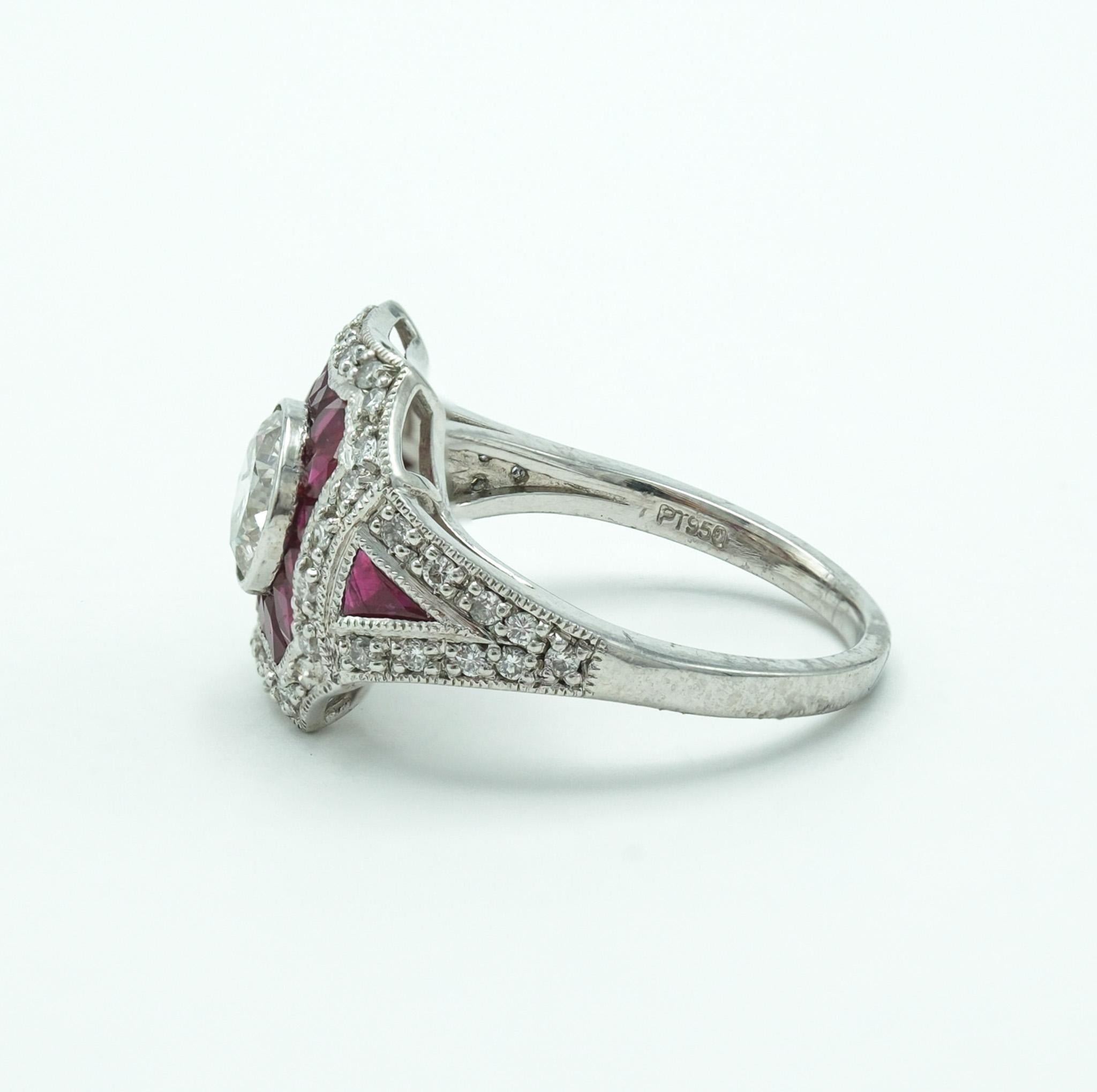 This platinum ring masterfully showcases  a 0.9 carat round diamond, encased by 16 baguette cut rubies - showcasing a deep red and pink hue. Surrounding them is an outer halo of diamonds, with a combined diamond weight of 1.25 carats. Two triangle