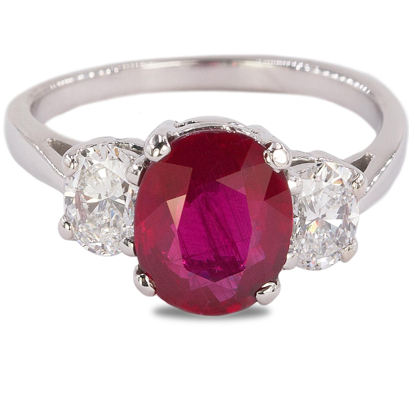 Platinum ring with AGL certified 2.60 carat ruby and two D color VS clarity oval cut diamonds weighing 1.02 carats.