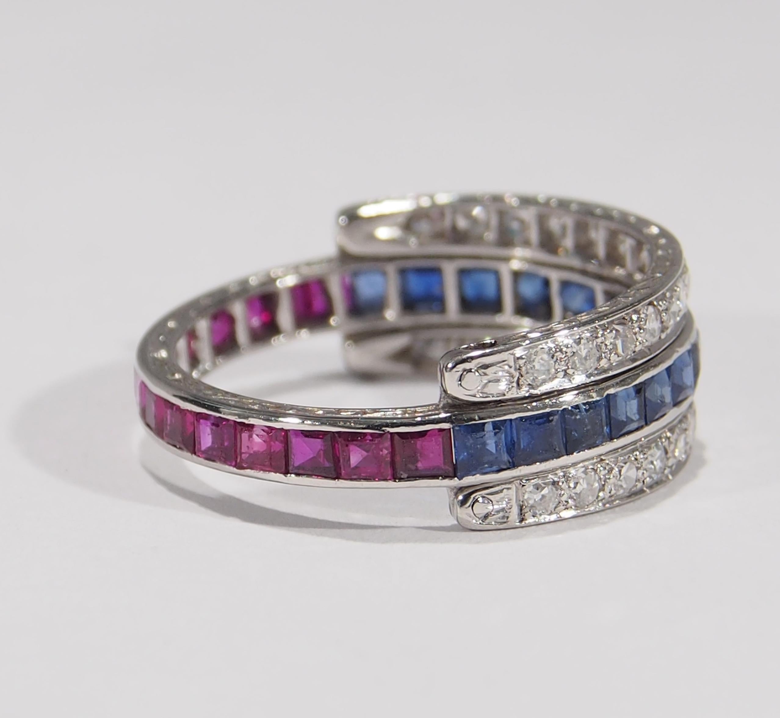 This is a unique Platinum Art Deco Style Interchangeable ring. In the center is an eternity ring set halfway around with (16) Princess Cut Sapphires, approximately 1.28 total weight and halfway with (15) Princess Cut Rubies, approximately 1.20 total