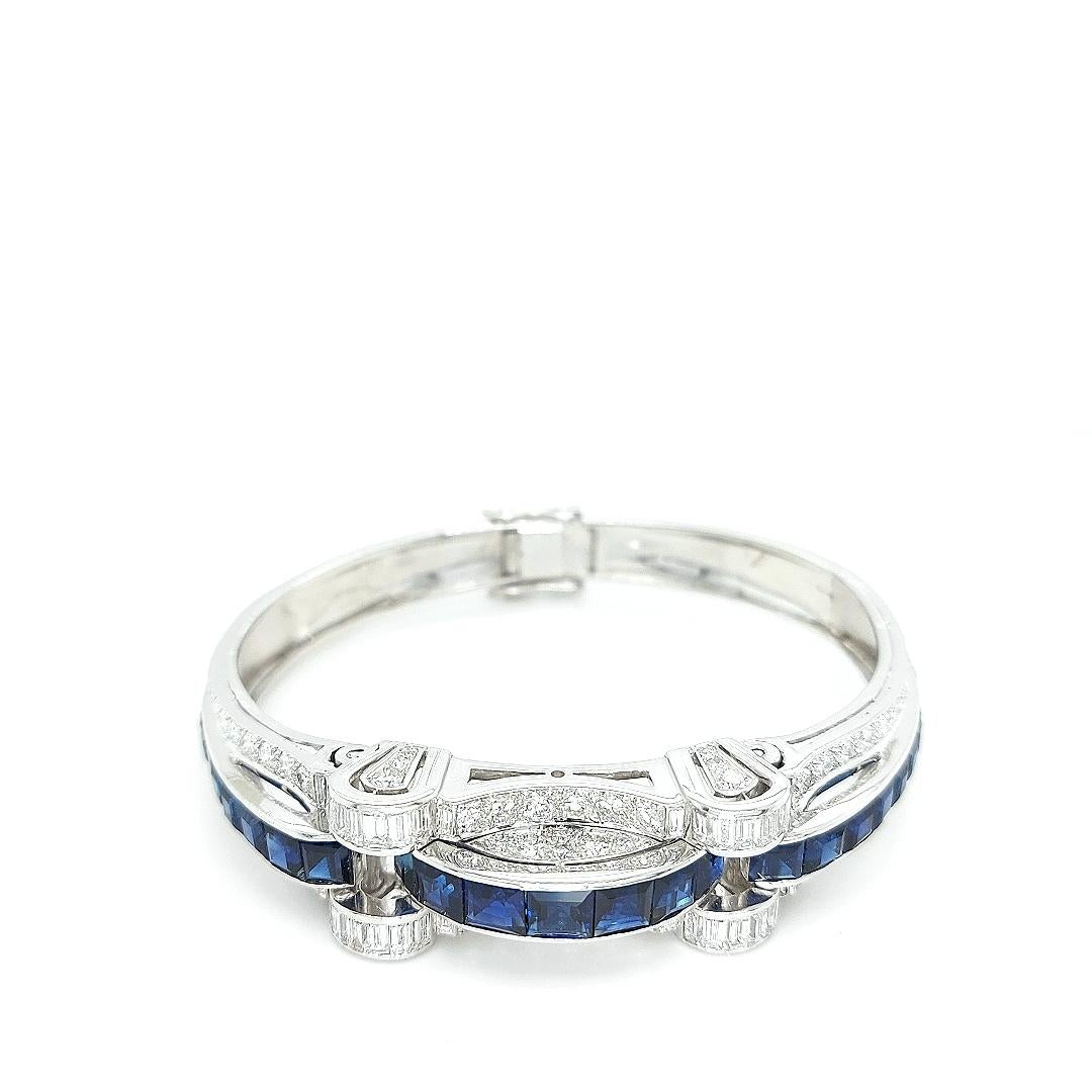 Incredible bangle in platinum set with sapphires and diamonds.

Amazing Platinum bangle making the finishing touch for every occasion.

Diamonds: 72 brilliant cut diamonds (2,85 ct)  & 28 baguette cut diamonds (2,24 ct)

Sapphire: 29 square cut