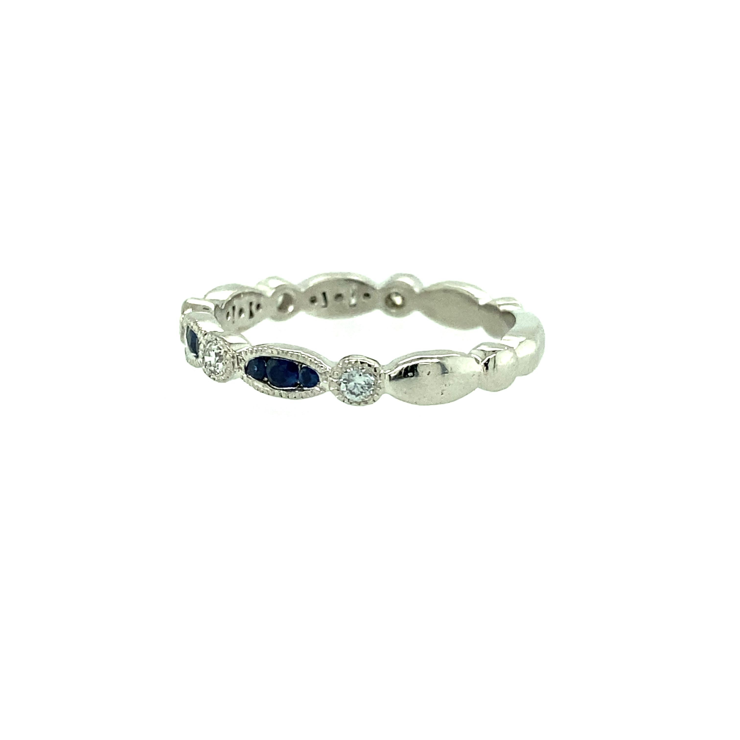 One platinum estate wedding band set with twelve natural blue sapphires, 0.25 carat total weight and five brilliant cut diamonds, 0.15 carat total weight with matching H/I color and SI clarity.  The ring measures 2.75mm wide and weighs 3.48 grams